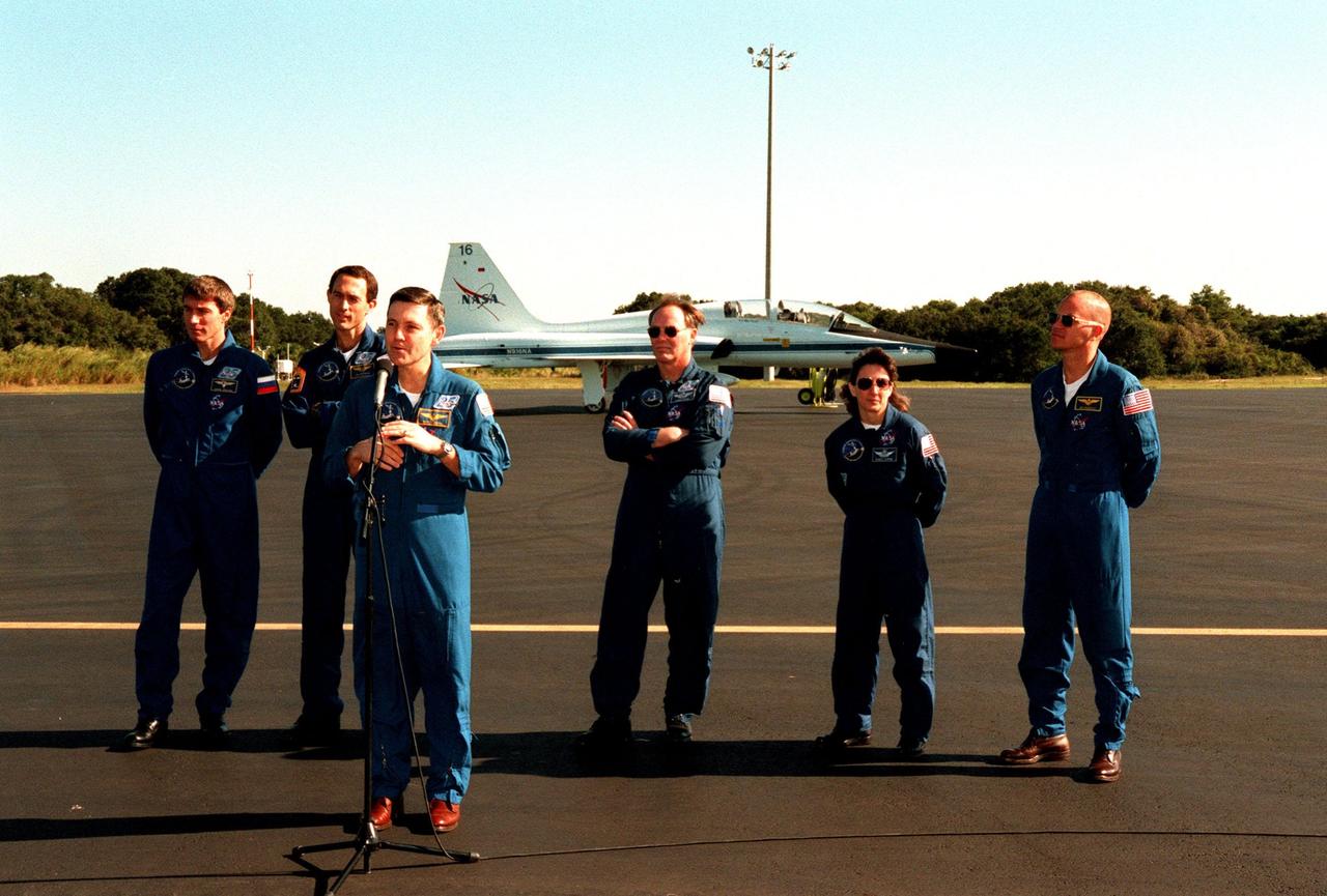 The STS-88 crew meet with news media at the Cape Canaveral Air Station Skid Strip before leaving for Houston. From left, they are Mission Specialists Sergei Konstantinovich Krikalev and James H. Newman, Commander Robert D. Cabana (at microphone), Mission Specialists Jerry L. Ross and Nancy J. Currie, and Pilot Frederick W. "Rick" Sturckow. The STS-88 crew returned Dec. 15 from a 12-day mission on orbit constructing the first elements of the International Space Station, the U.S.-built Unity connecting module and Russian-built Zarya control module