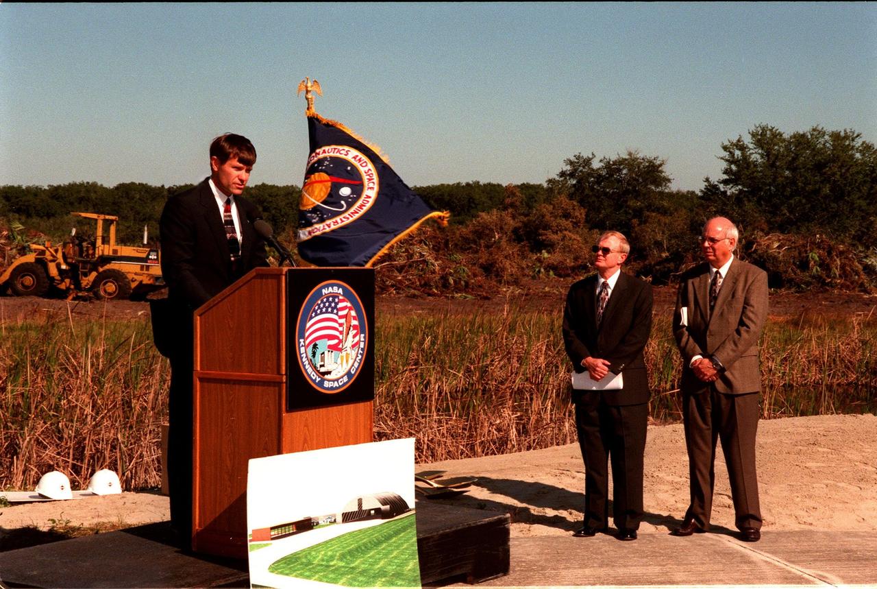 Donald McMonagle (left), manager, Launch Integration, speaks to federal and state elected officials during the ground breaking ceremony for a multi-purpose hangar, phase one of the Reusable Launch Vehicle (RLV) Support Complex to be built near the Shuttle Landing Facility. At right are Center Director Roy Bridges and Executive Director of the Spaceport Florida Authority (SFA) Ed O'Connor. The new complex is jointly funded by SFA, NASA's Space Shuttle Program and Kennedy Space Center. It is intended to support the Space Shuttle and other RLV land X-vehicle systems. Completion is expected by the year 2000