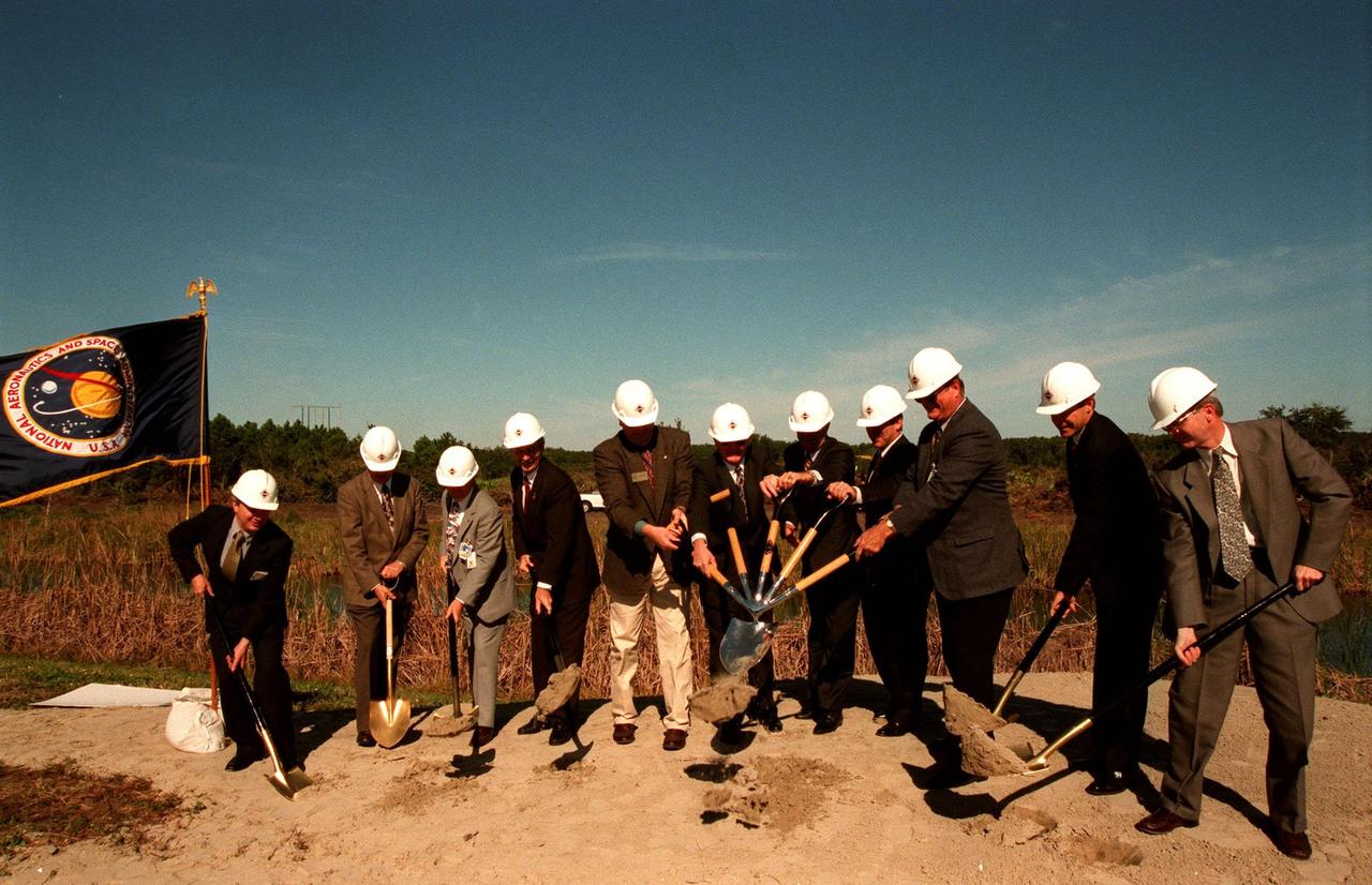 Federal, state, NASA, KSC and Space Florida Authority (SFA) officials dig in at the planned site of a multi-purpose hangar, phase one of the Reusable Launch Vehicle (RLV) Support Complex to be built near the Shuttle Landing Facility. From left, they are a representative from Rush Construction; Ed O'Connor, executive director of the Spaceport Florida Authority (SFA); Stephen T. Black, Lockheed Martin technical operations program manager; Warren Wiley, deputy director of engineering development; Tom Best, district director, representing U.S. Congressman Dave Weldon; Roy Bridges, director, Kennedy Space Center; Bill Posey, 32nd district representative; Randy Ball, state representative; Charlie Bronson, state senator; Donald McMonagle, manager of launch integration; and John London, Marshall Space Flight Center X-34 program manager. The new complex is jointly funded by SFA, NASA's Space Shuttle Program and Kennedy Space Center. It is intended to support the Space Shuttle and other RLV and X-vehicle systems. Completion is expected by the year 2000