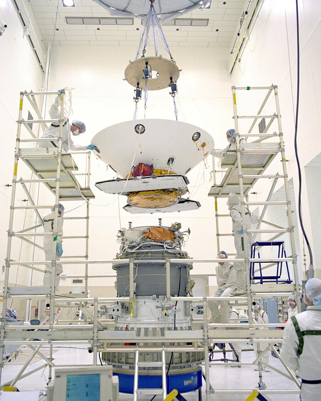 In the Spacecraft Assembly and Encapsulation Facility-2 (SAEF-2), the <a href="http://www-pao.ksc.nasa.gov/kscpao/captions/subjects/mars.htm"><b>Mars Polar Lander</b></a> is lowered onto the third stage of the Boeing Delta II rocket before it is transported to Launch Pad 17B, Cape Canaveral Air Station. The lander, which will be launched on Jan. 3, 1999, is a solar-powered spacecraft designed to touch down on the Martian surface near the northern-most boundary of the south pole in order to study the water cycle there. The lander also will help scientists learn more about climate change and current resources on Mars, studying such things as frost, dust, water vapor and condensates in the Martian atmosphere. It is the second spacecraft to be launched in a pair of Mars '98 missions. The first is the Mars Climate Orbiter, which was launched aboard a Delta II rocket from Launch Complex 17A on Dec. 11, 1998