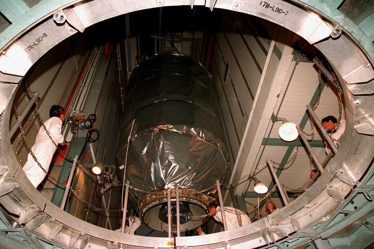 KENNEDY SPACE CENTER, FLA. -- Inside the gantry at Launch Complex 17B, Cape Canaveral Air Station, the Mars Polar Lander spacecraft is lowered to mate it with the Boeing Delta II rocket that will launch it on Jan. 3, 1999. The lander is a solar-powered spacecraft designed to touch down on the Martian surface near the northern-most boundary of the south pole in order to study the water cycle there. The lander also will help scientists learn more about climate change and current resources on Mars, studying such things as frost, dust, water vapor and condensates in the Martian atmosphere. It is the second spacecraft to be launched in a pair of Mars Surveyor'98 missions. The first is the Mars Climate Orbiter, which was launched aboard a Delta II rocket from Launch Complex 17A on Dec. 11, 1998