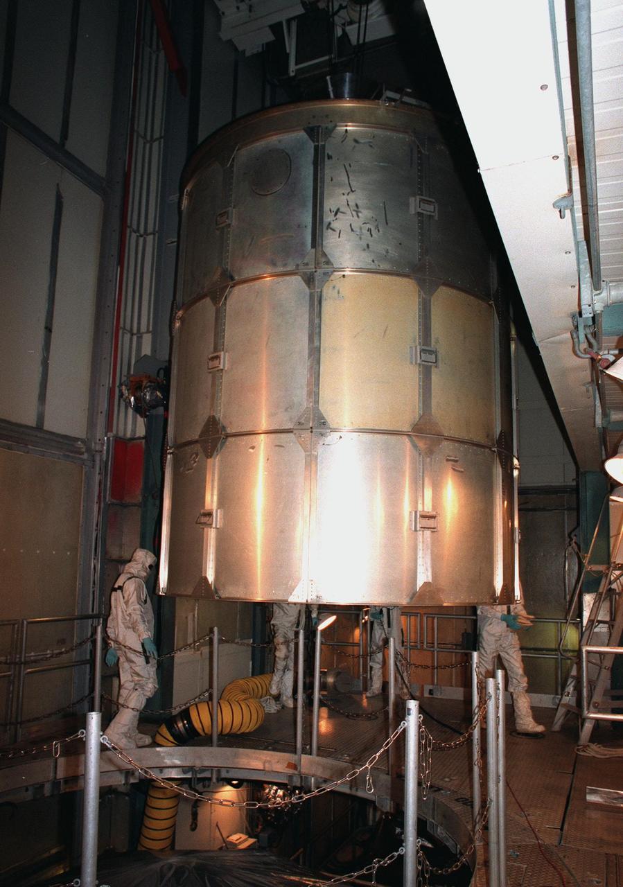 KENNEDY SPACE CENTER, FLA. -- At Launch Complex 17B, Cape Canaveral Air Station, the protective covering on the Mars Polar Lander is lifted up and out of the way. The lander, in the opening below, is being mated to the Boeing Delta II rocket that will launch it on Jan. 3, 1999. The lander is a solar-powered spacecraft designed to touch down on the Martian surface near the northern-most boundary of the south pole in order to study the water cycle there. The lander also will help scientists learn more about climate change and current resources on Mars, studying such things as frost, dust, water vapor and condensates in the Martian atmosphere. It is the second spacecraft to be launched in a pair of Mars Surveyor'98 missions. The first is the Mars Climate Orbiter, which was launched aboard a Delta II rocket from Launch Complex 17A on Dec. 11, 1998