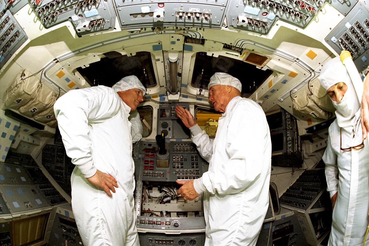 Astronaut Stephen Oswald, at left, listens to Ohio Senator John Glenn on the orbiter Columbia's middeck as the senator asks questions regarding Shuttle operations at the Orbiter Processing Facility 3 at Kennedy Space Center. Senator Glenn arrived at KSC on Jan. 20 to tour KSC operational areas and to view the launch of STS-89 later this week. Glenn, who made history in 1962 as the first American to orbit the Earth, completing three orbits in a five-hour flight aboard Friendship 7, will fly his second space mission aboard Space Shuttle Discovery this October. Glenn is retiring from the Senate at the end of this year and will be a payload specialist aboard STS-95