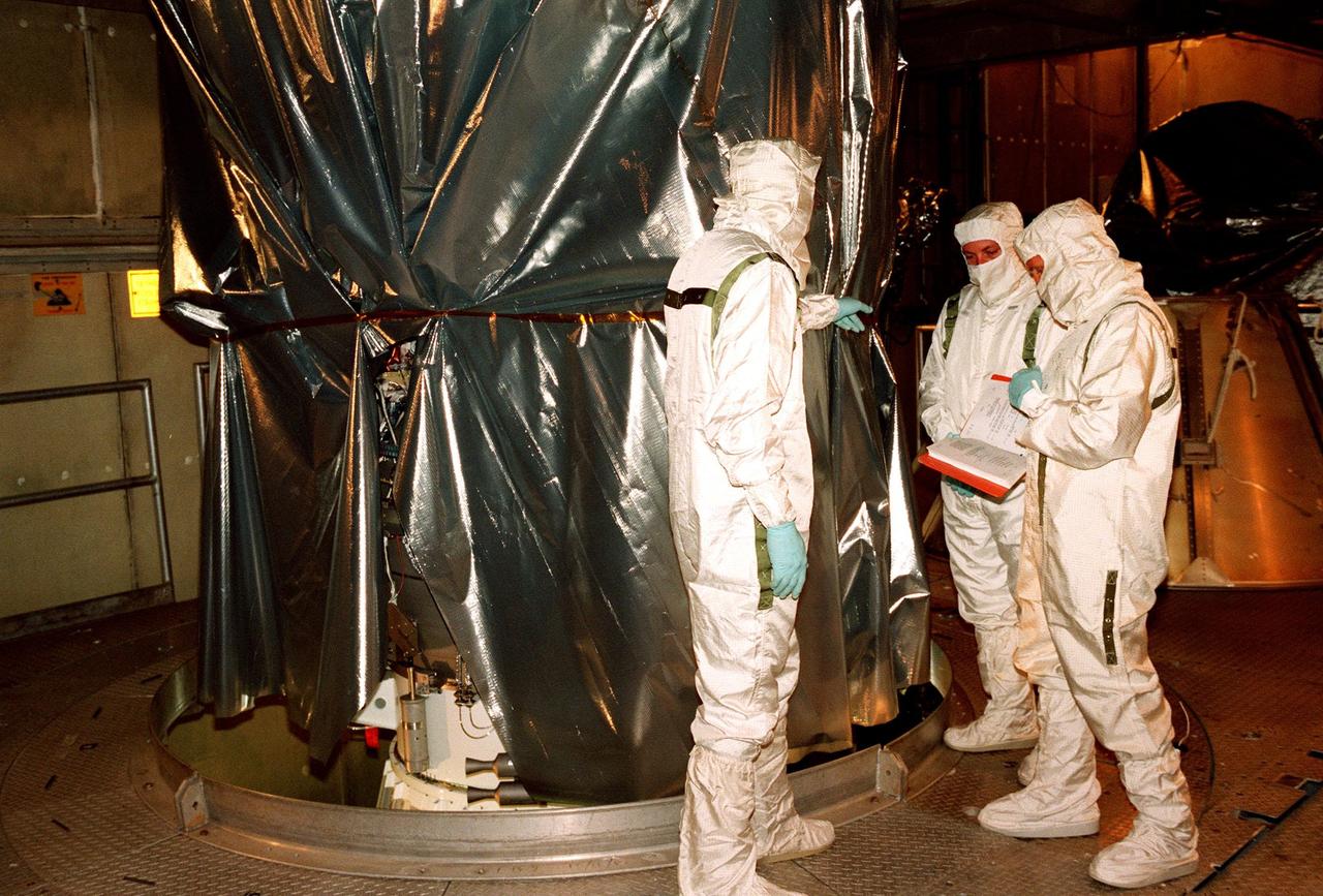 KENNEDY SPACE CENTER, FLA. -- At Launch Complex 17B, Cape Canaveral Air Station, workers get ready to remove the protective wrapping on the Mars Polar Lander to be launched aboard a Boeing Delta II rocket on Jan. 3, 1999. The lander is a solar-powered spacecraft designed to touch down on the Martian surface near the northern-most boundary of the south pole in order to study the water cycle there. The lander also will help scientists learn more about climate change and current resources on Mars, studying such things as frost, dust, water vapor and condensates in the Martian atmosphere. It is the second spacecraft to be launched in a pair of Mars Surveyor'98 missions. The first is the Mars Climate Orbiter, which was launched aboard a Delta II rocket from Launch Complex 17A on Dec. 11, 1998