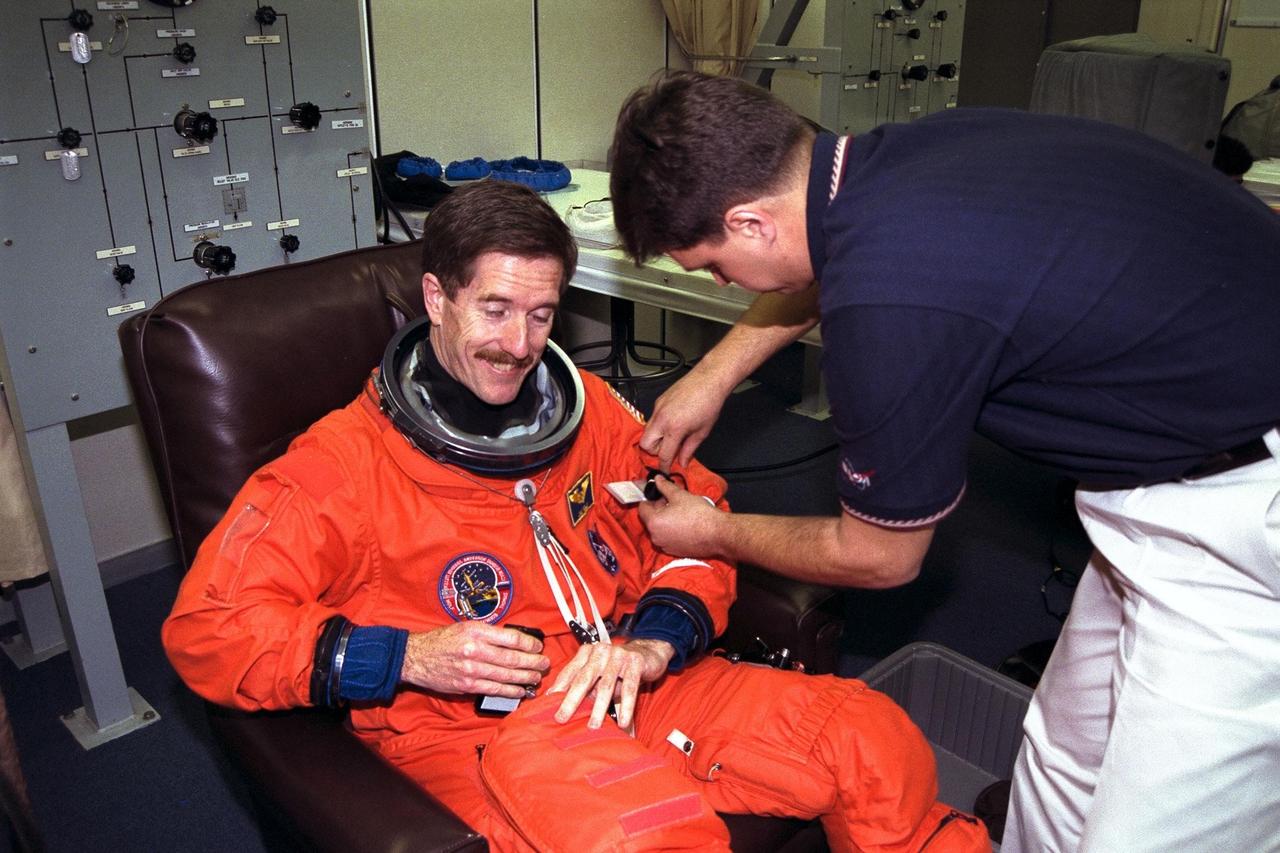 STS-89 Mission Specialist James Reilly, Ph.D., smiles as he completes the donning of his launch/entry suit in the Operations and Checkout (O&C) Building. He holds a doctorate in geosciences. He and six fellow crew members will shortly depart the O&C and head for Launch Pad 39A, where the Space Shuttle Endeavour will lift off during a launch window that opens at 9:43 p.m. EST, Jan. 22. STS-89 is the eighth of nine planned missions to dock the Space Shuttle with Russia's Mir space station