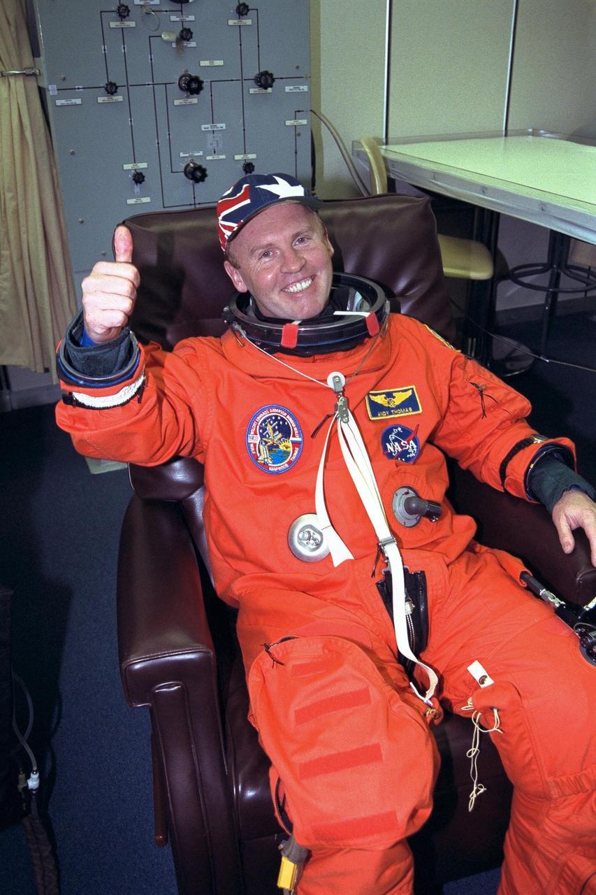 STS-89 Mission Specialist Andrew Thomas, Ph.D., gives a ‘thumbs up’ as he completes the donning of his launch/entry suit in the Operations and Checkout (O&C) Building. In June 1995, he was named as payload commander for STS-77 and flew his first flight in space on Endeavour in May 1996. He and six fellow crew members will soon depart the O&C and head for Launch Pad 39A, where the Space Shuttle Endeavour will lift off during a launch window that opens at 9:43 p.m. EST, Jan. 22. STS-89 is the eighth of nine planned missions to dock the Space Shuttle with Russia's Mir space station, where Dr. Thomas will succeed David Wolf, M.D