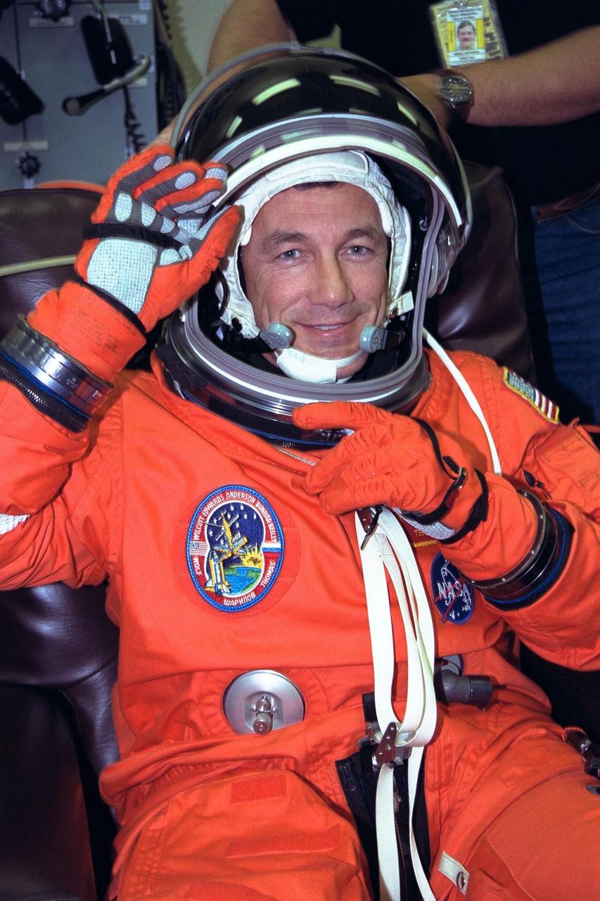 STS-89 Commander Terrence Wilcutt smiles as he completes the donning of his launch/entry suit in the Operations and Checkout (O&C) Building. A veteran of two space flights, he has logged more than 512 hours in space. He served as pilot on STS-68 and STS-79. He and six fellow crew members will soon depart the O&C and head for Launch Pad 39A, where the Space Shuttle Endeavour will lift off during a launch window that opens at 9:43 p.m. EST, Jan. 22. STS-89 is the eighth of nine planned missions to dock the Space Shuttle with Russia's Mir space station