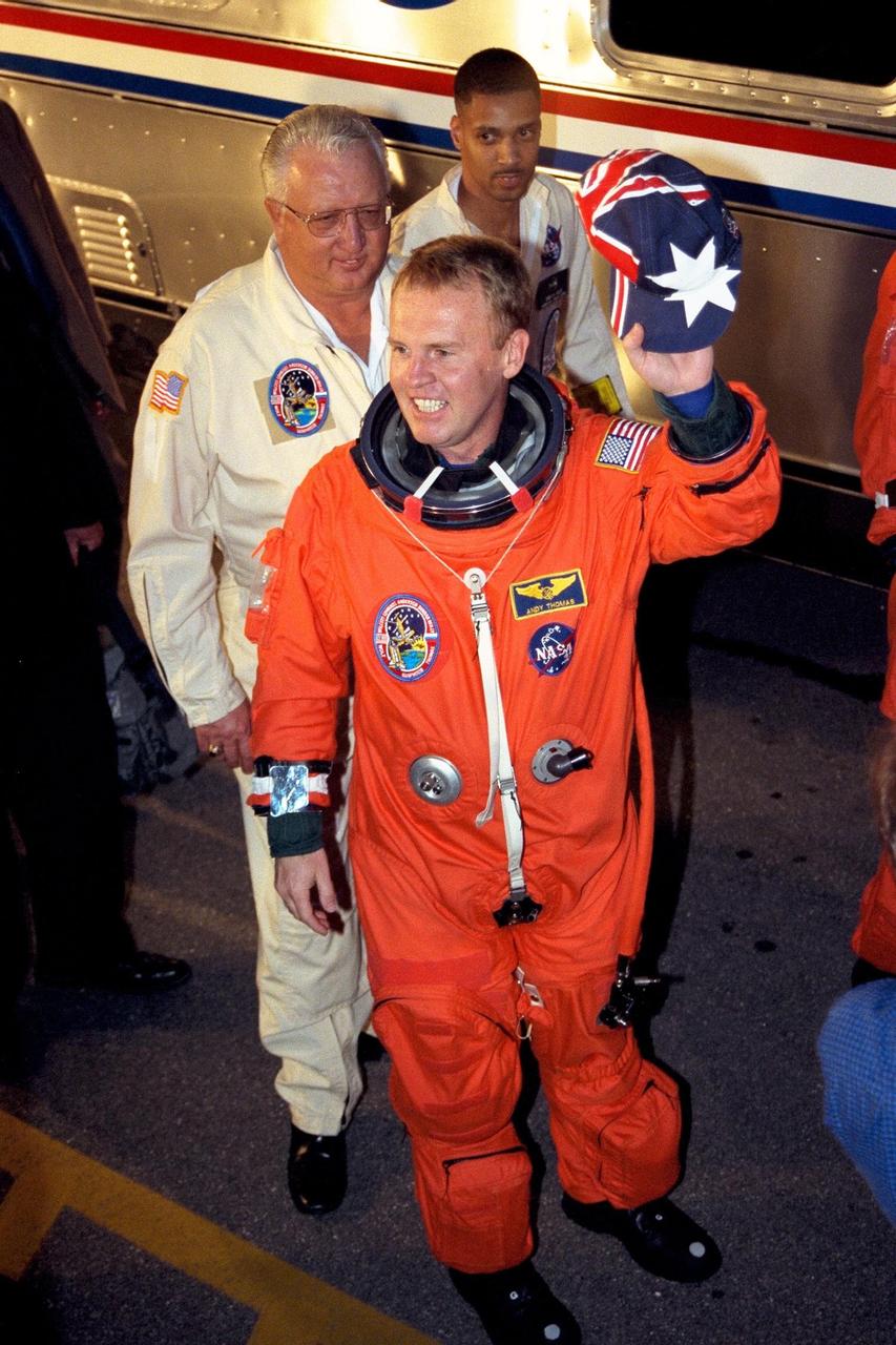 STS-89 Mission Specialist Andrew Thomas, Ph.D., smiles and waves his Australian hat to the crowd outside of the Operations and Checkout Building at KSC as he heads toward the Astrovan that will transport him to Launch Pad 39A. There, the Space Shuttle Endeavour awaits to take the STS-89 crew to Russia’s Mir space station, where Dr. Thomas, who was born and educated in South Australia, will succeed David Wolf, M.D. STS-89, slated for a 9:48 p.m. EST liftoff Jan. 22, is the eighth docking with the Russian Space Station Mir, the first Mir docking for Endeavour (all previous dockings were made by Atlantis), and the first launch of 1998