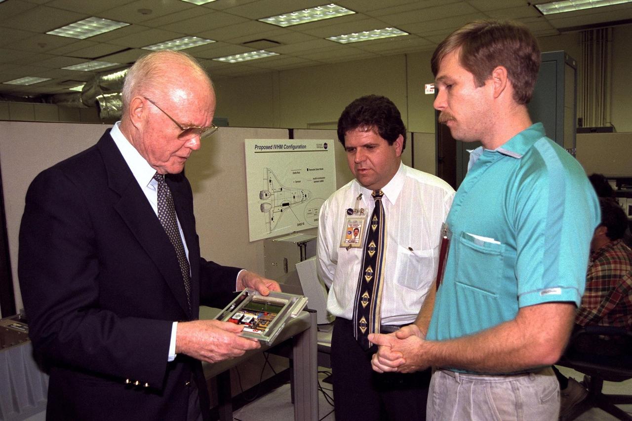 Ohio Senator John Glenn, at left, enjoys a tour of the Engineering Development Laboratory at Kennedy Space Center. Standing with Senator Glenn are, left to right, Chief Engineer Hugo Delgado and Design Engineer David Kruhm, both of NASA Advanced Development and Shuttle Upgrades. Senator Glenn arrived at KSC on Jan. 20 to tour KSC operational areas and to view the launch of STS-89. Glenn, who made history in 1962 as the first American to orbit the Earth, completing three orbits in a five-hour flight aboard Friendship 7, will fly his second space mission aboard Space Shuttle Discovery this October. Glenn is retiring from the Senate at the end of this year and will be a payload specialist aboard STS-95