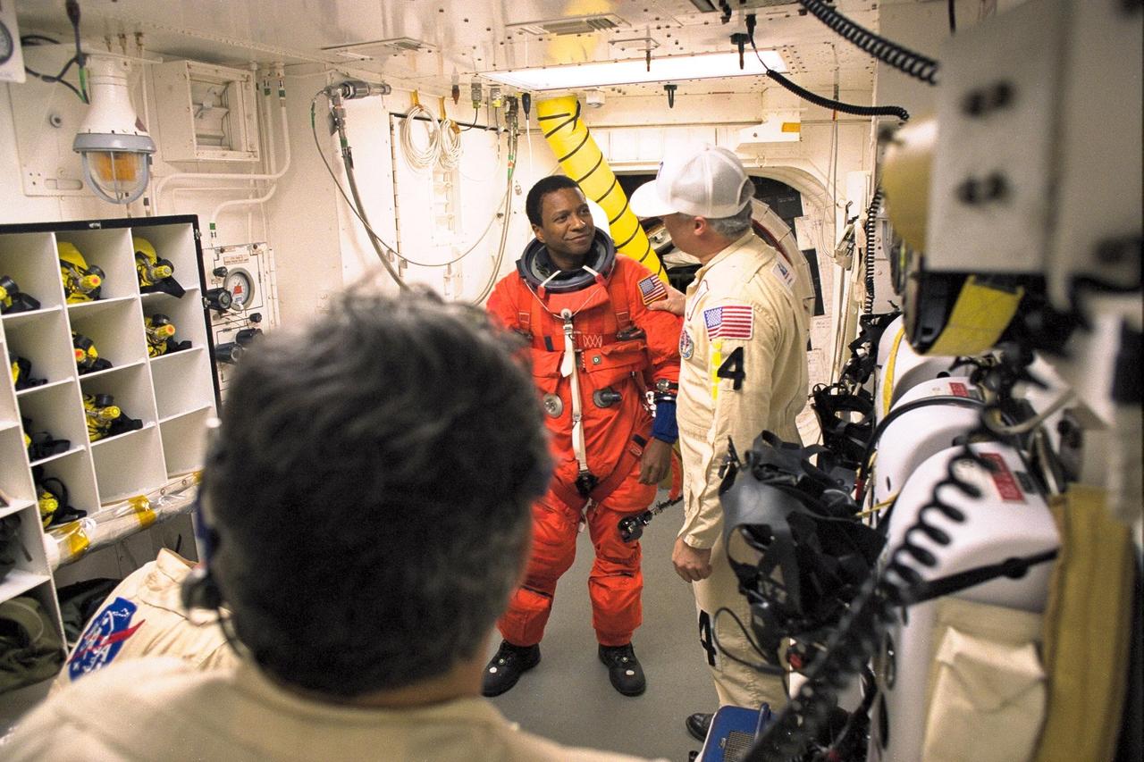 STS-89 Mission Specialist Michael Anderson is assisted with his ascent and re-entry flight suit in the white room at Launch Pad 39A before entering Space Shuttle Endeavour for launch. The STS-89 mission will be the eighth docking of the Space Shuttle with the Russian Space Station Mir. After docking, Mission Specialist Andrew Thomas, Ph.D., will transfer to the space station, succeeding David Wolf, M.D., who will return to Earth aboard Endeavour. Dr. Thomas will live and work on Mir until June. STS-89 is scheduled for a Jan. 22 liftoff at 9:48 p.m