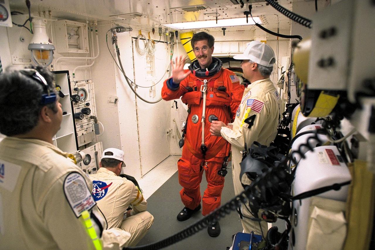STS-89 Mission Specialist James Reilly, Ph.D., is assisted with his ascent and re-entry flight suit in the white room at Launch Pad 39A before entering Space Shuttle Endeavour for launch. The STS-89 mission will be the eighth docking of the Space Shuttle with the Russian Space Station Mir. After docking, Mission Specialist Andrew Thomas, Ph.D., will transfer to the space station, succeeding David Wolf, M.D., who will return to Earth aboard Endeavour. Dr. Thomas will live and work on Mir until June. STS-89 is scheduled for a Jan. 22 liftoff at 9:48 p.m