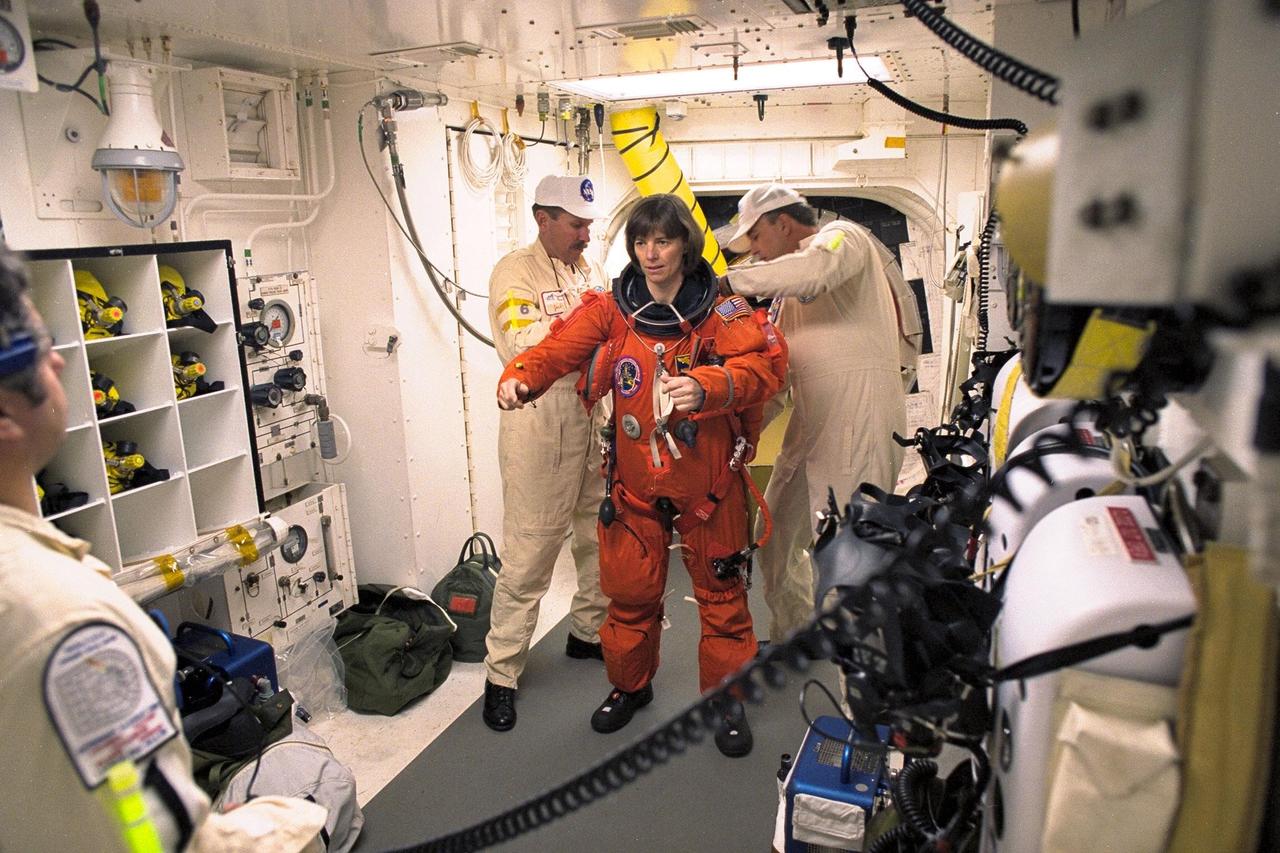 STS-89 Mission Specialist Bonnie Dunbar, Ph.D., is assisted with her ascent and re-entry flight suit in the white room at Launch Pad 39A before entering Space Shuttle Endeavour for launch. The STS-89 mission will be the eighth docking of the Space Shuttle with the Russian Space Station Mir. After docking, Mission Specialist Andrew Thomas, Ph.D., will transfer to the space station, succeeding David Wolf, M.D., who will return to Earth aboard Endeavour. Dr. Thomas will live and work on Mir until June. STS-89 is scheduled for a Jan. 22 liftoff at 9:48 p.m
