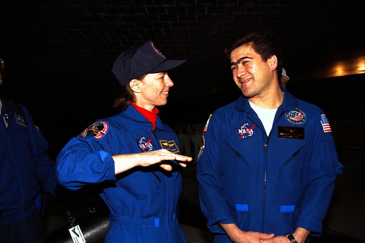 KENNEDY SPACE CENTER, FLA. -- STS-89 Mission Specialist Bonnie Dunbar, Ph.D., at left, discusses the mission with Mission Specialist Salizhan Sharipov of the Russian Space Agency under the orbiter Endeavour after it landed on Runway 15 at KSC’s Shuttle Landing Facility Jan. 31. The 89th Space Shuttle mission was the 42nd (and 13th consecutive) landing of the orbiter at KSC, and STS-89 was the eighth of nine planned dockings of the orbiter with the Russian Space Station Mir. STS-89 Mission Specialist Andrew Thomas, Ph.D., succeeded NASA astronaut and Mir 24 crew member David Wolf, M.D., who was on the Russian space station since late September 1997. Dr. Wolf returned to Earth on Endeavour with the remainder of the STS-89 crew, including Commander Terrence Wilcutt; Pilot Joe Edwards Jr.; and Mission Specialists James Reilly, Ph.D.; Michael Anderson; Dr. Dunbar; and Sharipov. Dr. Thomas is scheduled to remain on Mir until the STS-91 Shuttle mission returns in June 1998. In addition to the docking and crew exchange, STS-89 included the transfer of science, logistical equipment and supplies between the two orbiting spacecrafts