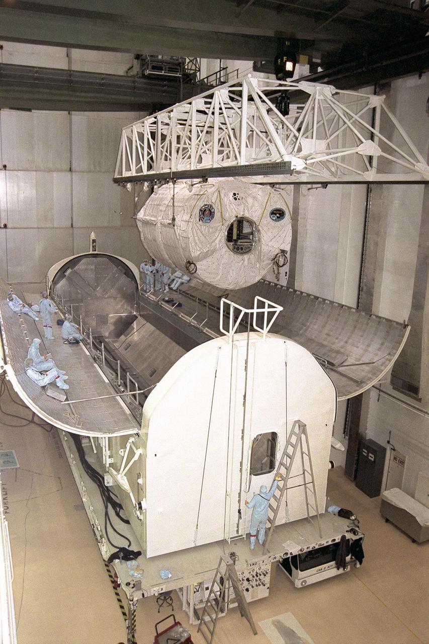 KENNEDY SPACE CENTER, FLA. -- The STS-90 Neurolab payload is lowered into its payload canister in KSC's Operations and Checkout Building. Investigations during the Neurolab mission will focus on the effects of microgravity on the nervous system. Specifically, experiments will study the adaptation of the vestibular system, the central nervous system, and the pathways that control the ability to sense location in the absence of gravity, as well as the effect of microgravity on a developing nervous system. The crew of STS-90, slated for launch in April, will include Commander Richard Searfoss, Pilot Scott Altman, Mission Specialists Richard Linnehan, Dafydd (Dave) Williams, M.D., and Kathryn (Kay) Hire, and Payload Specialists Jay Buckey, M.D., and James Pawelczyk, Ph.D