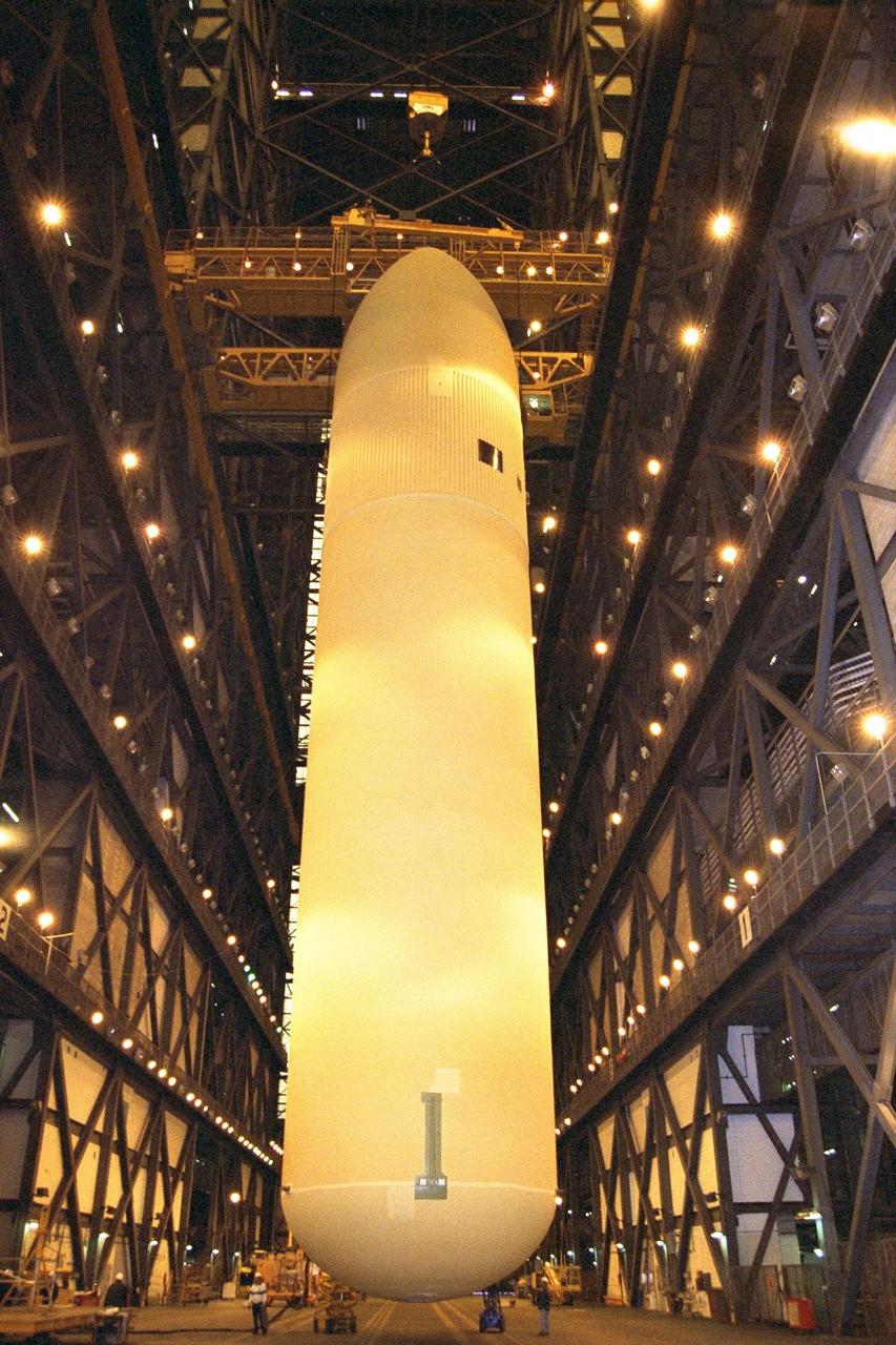 KENNEDY SPACE CENTER, FLA. -- The Space Shuttle's first super lightweight external tank is lifted in KSC's Vehicle Assembly Building for STS-91 pre-flight processing. STS-91 is targeted for launch in late May. The improved tank is 7,500 pounds lighter than its predecessors and was developed to increase the Shuttle payload capacity on International Space Station assembly flights. Major changes to the lighter tank include the use of new materials and a revised internal design. The new liquid oxygen and liquid hydrogen tanks are constructed of aluminum lithium a lighter, stronger material than the metal alloy currently used. The redesigned walls of the liquid hydrogen tank were machined to provide additional strength and stability as well