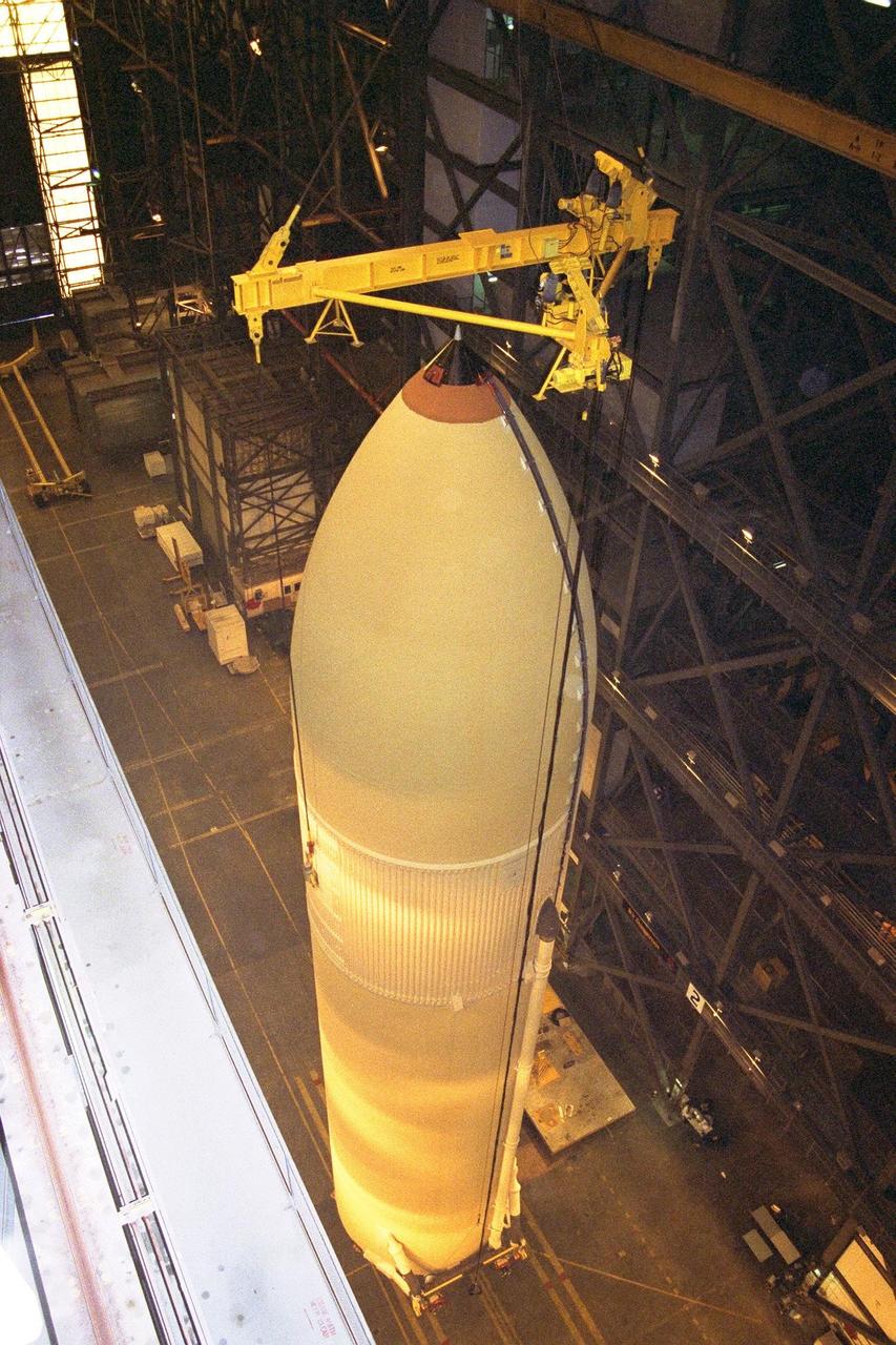 KENNEDY SPACE CENTER, FLA. -- The Space Shuttle's first super lightweight external tank is lifted in KSC's Vehicle Assembly Building for STS-91 pre-flight processing. STS-91 is targeted for launch in late May. The improved tank is 7,500 pounds lighter than its predecessors and was developed to increase the Shuttle payload capacity on International Space Station assembly flights. Major changes to the lighter tank include the use of new materials and a revised internal design. The new liquid oxygen and liquid hydrogen tanks are constructed of aluminum lithium a lighter, stronger material than the metal alloy currently used. The redesigned walls of the liquid hydrogen tank were machined to provide additional strength and stability as well