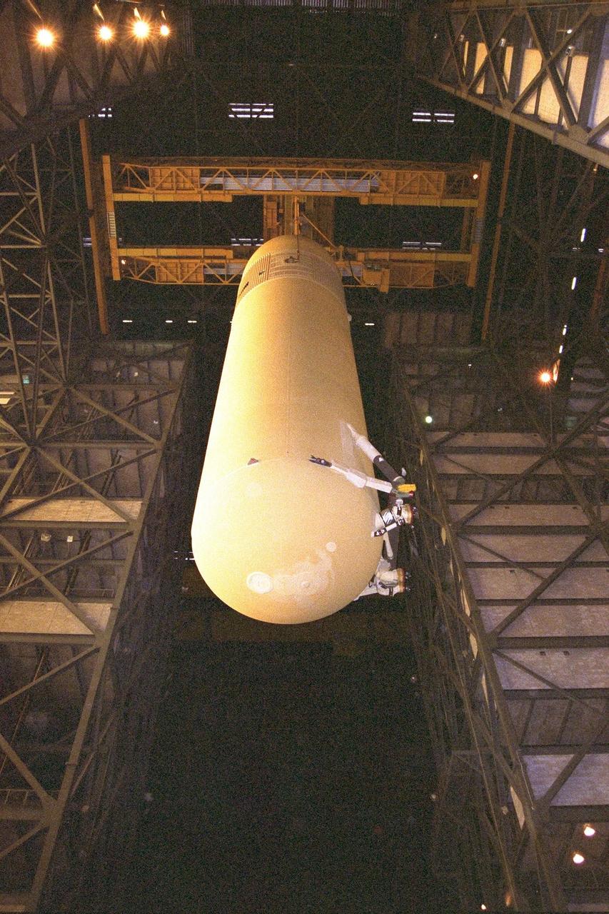 KENNEDY SPACE CENTER, FLA. -- The Space Shuttle's first super lightweight external tank is lifted in KSC's Vehicle Assembly Building for STS-91 pre-flight processing. STS-91 is targeted for launch in late May. The improved tank is 7,500 pounds lighter than its predecessors and was developed to increase the Shuttle payload capacity on International Space Station assembly flights. Major changes to the lighter tank include the use of new materials and a revised internal design. The new liquid oxygen and liquid hydrogen tanks are constructed of aluminum lithium a lighter, stronger material than the metal alloy currently used. The redesigned walls of the liquid hydrogen tank were machined to provide additional strength and stability as well
