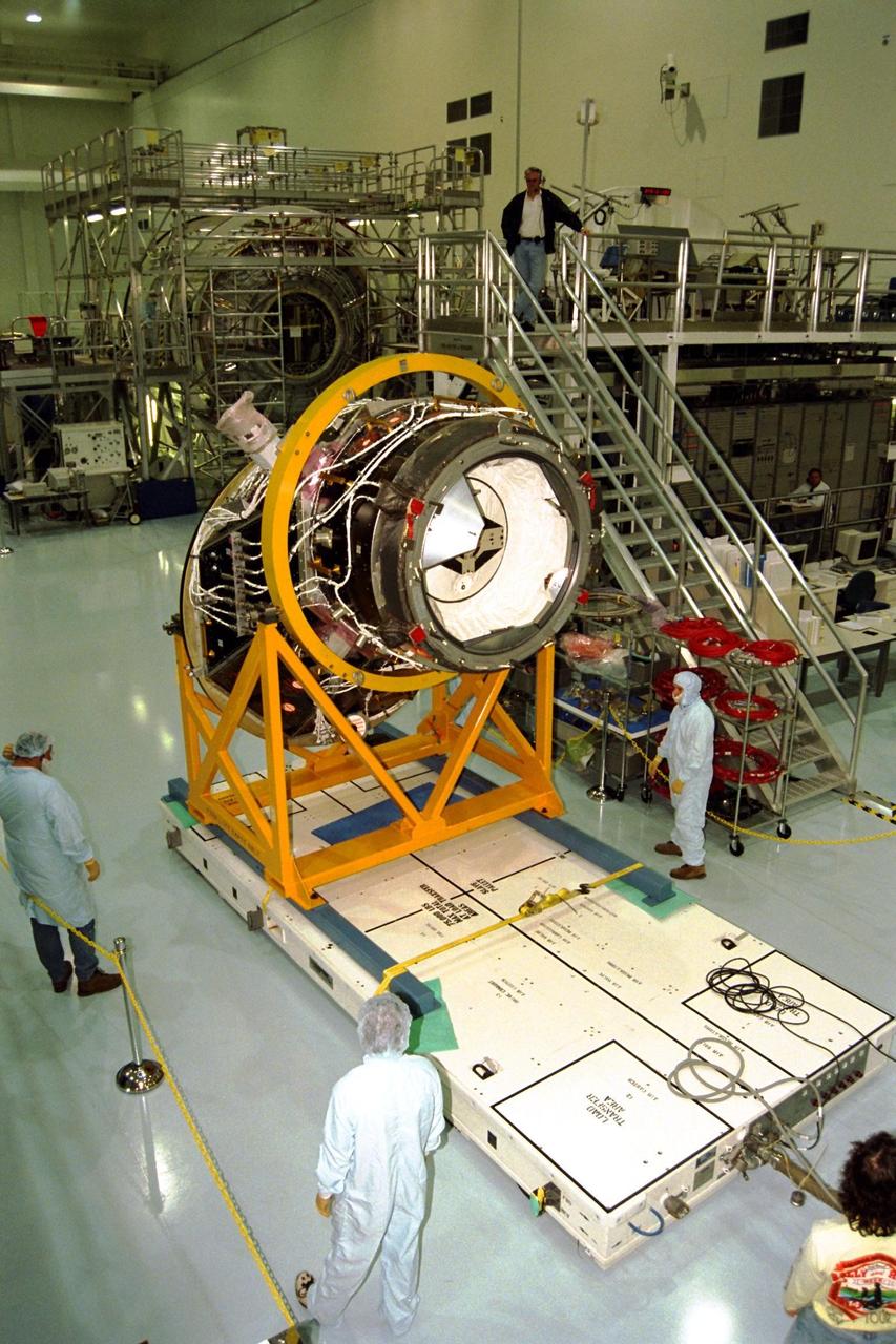 KENNEDY SPACE CENTER, FLA. -- The Pressurized Mating Adapter (PMA)-2 for the International Space Station (ISS), seen here in its yellow workstand, is moved on an air pallet toward Node 1, the space station’s structural building block, in KSC’s Space Station Processing Facility. This PMA is a cone-shaped connector to Node 1, which will have two PMAs attached once PMA-2 is mated with the node. The node and PMAs, which together will make up the first element of the ISS, are scheduled to be launched aboard the Space Shuttle Endeavour on STS-88