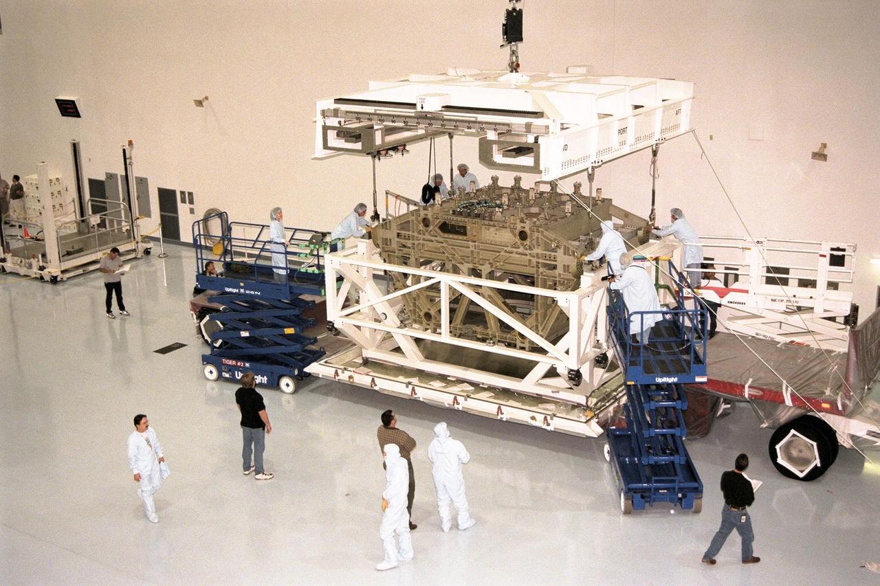 KENNEDY SPACE CENTER, FLA. -- The Z1 Integrated Truss Segment (ITS), a major element of the STS-92 mission scheduled for launch aboard Space Shuttle Atlantis in January 1999, is lowered into its workstand for processing in KSC's Space Station Processing Facility (SSPF). The Z-1 truss supports the staged buildup of International Space Station (ISS) on this third scheduled flight for ISS. The Z1 truss allows the temporary installation of the U.S. power module to Node 1. Early in the assembly sequence, the purpose of Z1 is to provide a mounting location for Ku-band and S-band telemetry and extravehicular activity (EVA) equipment. It also provides common berthing mechanism hardcover stowage. In addition, it will assist with the execution of nonpropulsive attitude control. The truss arrived at KSC on Feb. 17 for preflight processing in the SSPF