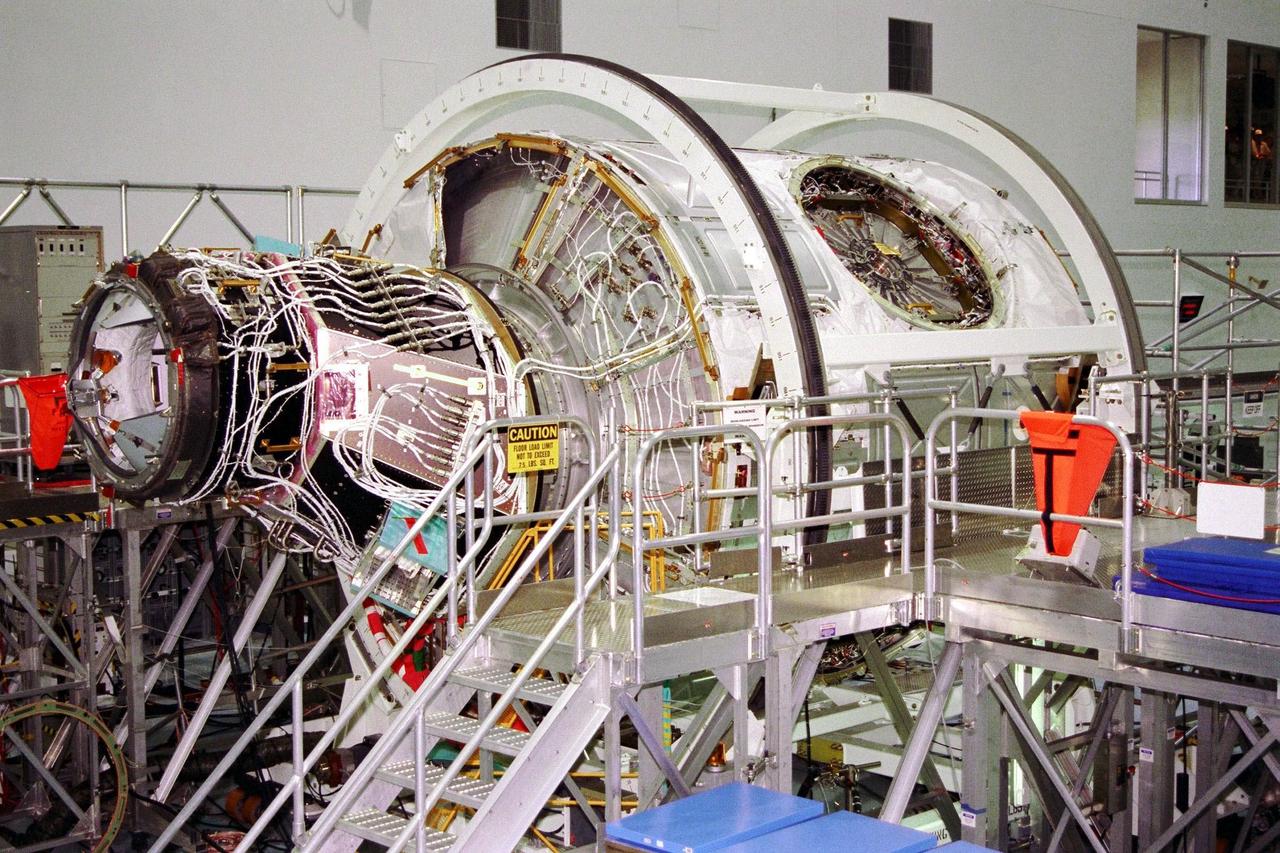 KENNEDY SPACE CENTER, FLA. -- Node 1, the first U.S. element for the International Space Station, and Pressurized Mating Adapter-1 (PMA-1) continue with prelaunch preparation activities at KSC's Space Station Processing Facility. The node and PMA-1 are seen here on a workstand getting ready to be moved the next day to a weight and balance stand for an interim weight and center of gravity determination. (The final determination is planned to be performed prior to transporting Node 1 to the launch pad.) Upon completing the interim determination, the node and PMA will be hoisted into the Shuttle payload transportation canister and the doors will be closed for a two-week leak check. Node 1 is a connecting passageway to the living and working areas of the space station. Node 1 is scheduled to fly on STS-88.