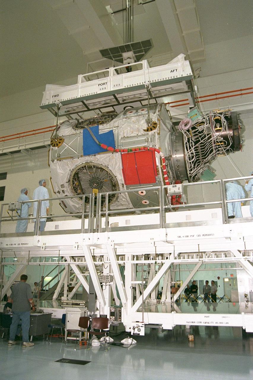 KENNEDY SPACE CENTER, FLA. -- Node 1, the first U.S. element for the International Space Station, and Pressurized Mating Adapter-1 (PMA-1) continue with prelaunch preparation activities at KSC's Space Station Processing Facility. Node 1 is a connecting passageway to the living and working areas of the space station. The node and PMA-1 are being lowered into an element rotation stand, or test stand, where they will undergo an interim weight and center of gravity determination. The final determination is planned to be performed prior to transporting Node 1 to the launch pad. Node 1 is scheduled to fly on STS-88