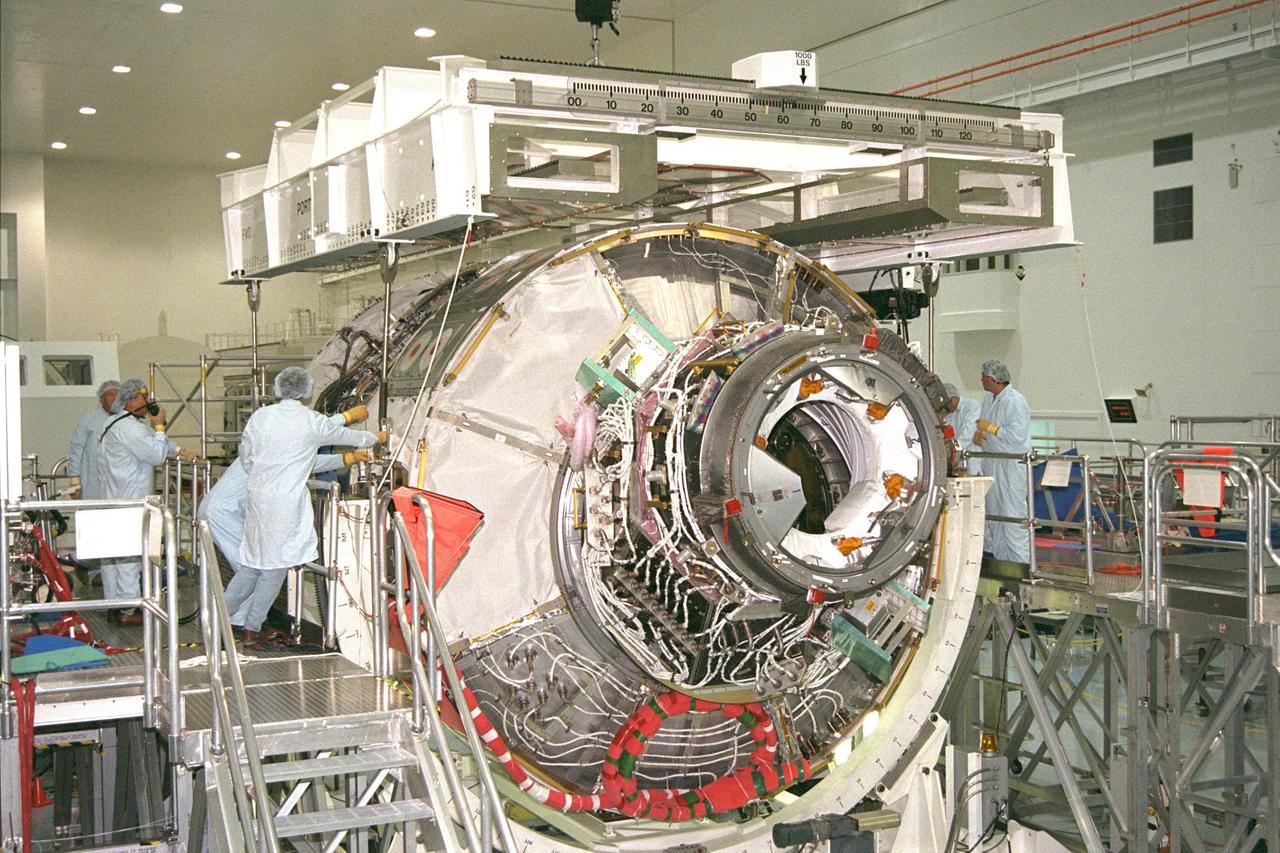 KENNEDY SPACE CENTER, FLA. -- Node 1, the first U.S. element for the International Space Station, and Pressurized Mating Adapter-1 (PMA-1) continue with prelaunch preparation activities at KSC's Space Station Processing Facility. Node 1 is a connecting passageway to the living and working areas of the space station. Boeing technicians are connecting cables to the node and PMA-1 to remove them from their workstand to an element rotation stand, or test stand, where they will undergo an interim weight and center of gravity determination. The final determination is planned to be performed prior to transporting Node 1 to the launch pad. Node 1 is scheduled to fly on STS-88