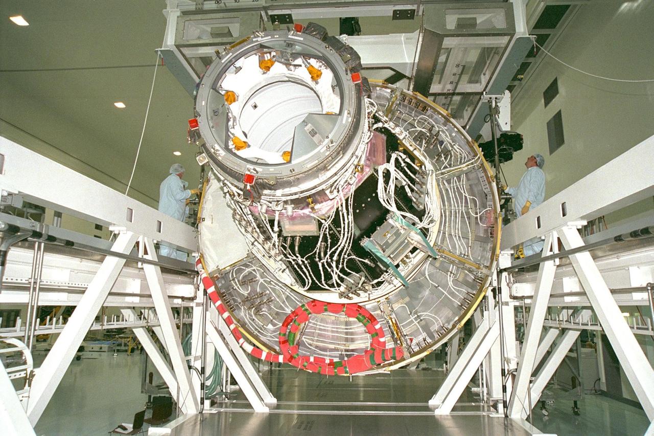 KENNEDY SPACE CENTER, FLA. -- Node 1, the first U.S. element for the International Space Station, and attached Pressurized Mating Adapter-1 continue with prelaunch preparation activities at KSC's Space Station Processing Facility. Node 1 is a connecting passageway to the living and working areas of the space station. The node and PMA-1 are being removed from the element rotation stand, or test stand, where they underwent an interim weight and center of gravity determination. (The final determination is planned to be performed prior to transporting Node 1 to the launch pad.) Now the node is being moved to the Shuttle payload transportation canister, where the doors will be closed for a two-week leak check. Node 1 is scheduled to fly on STS-88