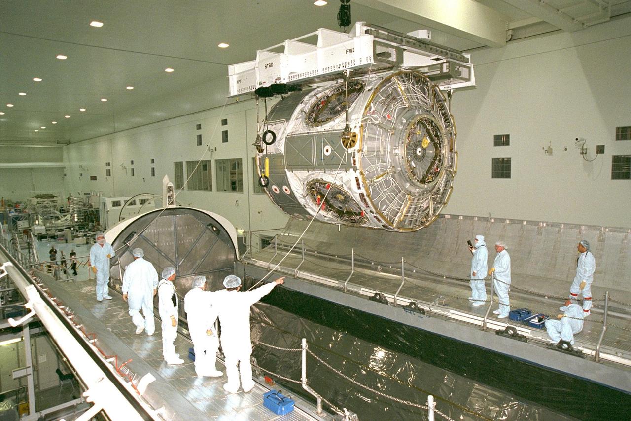 KENNEDY SPACE CENTER, FLA. -- Node 1, the first U.S. element for the International Space Station, and attached Pressurized Mating Adapter-1 (PMA-1) continue with prelaunch preparation activities at KSC's Space Station Processing Facility. Node 1 is a connecting passageway to the living and working areas of the space station. The node is seen here being moved into the Shuttle payload transportation canister, where the doors will be closed for a two-week leak check. The node and PMA-1 were moved to the canister from the element rotation stand, or test stand, where they underwent an interim weight and center of gravity determination. The final determination is planned to be performed prior to transporting Node 1 to the launch pad. Node 1 is scheduled to fly on STS-88