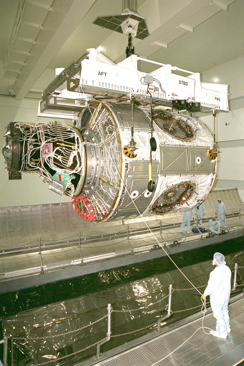 KENNEDY SPACE CENTER, FLA. -- Node 1, the first U.S. element for the International Space Station, and attached Pressurized Mating Adapter-1 (PMA-1) continue with prelaunch preparation activities at KSC's Space Station Processing Facility. Node 1 is a connecting passageway to the living and working areas of the space station. The node and PMA-1 are seen here being moved into the Shuttle payload transportation canister, where the doors will be closed for a two-week leak check. The node and PMA were moved to the canister from the element rotation stand, or test stand, where they underwent an interim weight and center of gravity determination. The final determination is planned to be performed prior to transporting Node 1 to the launch pad. Node 1 is scheduled to fly on STS-88