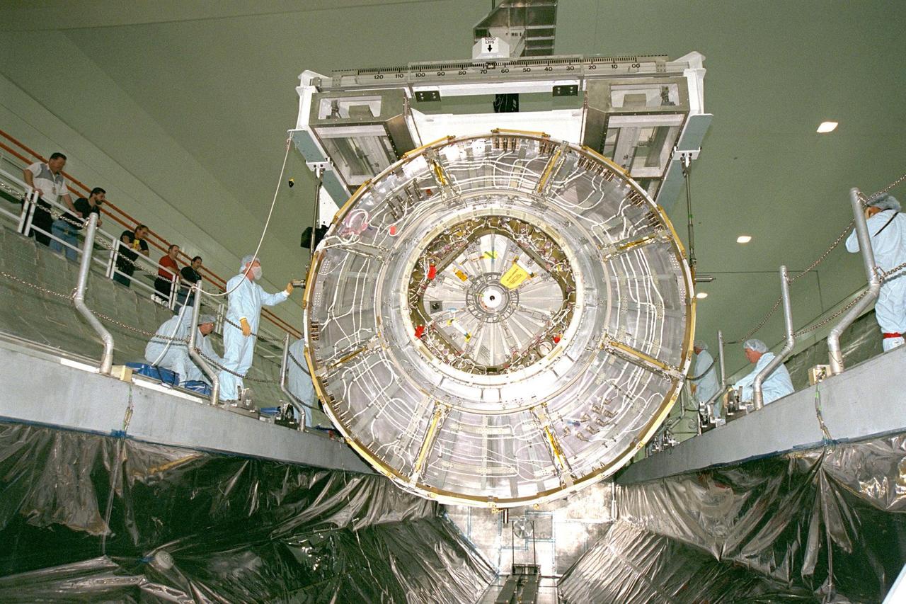 KENNEDY SPACE CENTER, FLA. -- Node 1, the first U.S. element for the International Space Station, and attached Pressurized Mating Adapter-1 (PMA-1) continue with prelaunch preparation activities at KSC's Space Station Processing Facility. Node 1 is a connecting passageway to the living and working areas of the space station. The node and PMA-1 are seen here being moved into the Shuttle payload transportation canister, where the doors will be closed for a two-week leak check. The node and PMA were moved to the canister from the element rotation stand, or test stand, where they underwent an interim weight and center of gravity determination. The final determination is planned to be performed prior to transporting Node 1 to the launch pad. Node 1 is scheduled to fly on STS-88