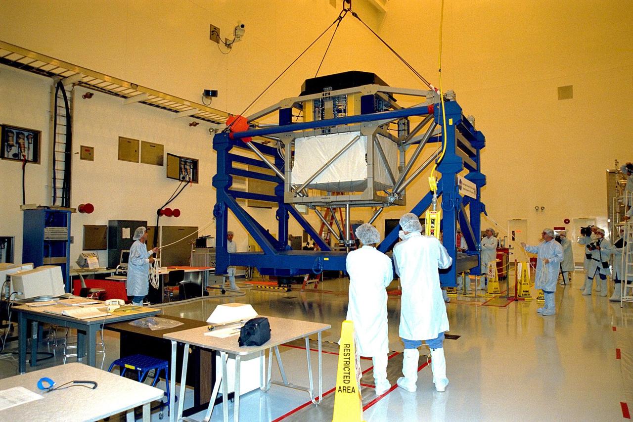 KENNEDY SPACE CENTER, FLA. -- The alpha-magnetic spectrometer (AMS-1) is lifted in KSC’s MultiPayload Processing Facility in preparation for a move to the Space Station Processing Facility via the Payload Environmental Transportation System. The STS-91 payload arrived at KSC in January and is scheduled to be flown on the 9th and final Mir docking mission, scheduled for launch in May. The objectives of the AMS-1 investigation are to search for anti-matter and dark matter in space and to study astrophysics. The STS-91 flight crew includes Commander Charles Precourt; Pilot Dominic Gorie; and Mission Specialists Wendy B. Lawrence; Franklin Chang-Diaz, Ph.D.; Janet Kavandi, Ph.D.; and Valery Ryumin, with the Russian Space Agency. After docking with the Russian Space Station Mir, Mission Specialist Andrew Thomas, Ph.D., will join the STS-91 crew and return to Earth aboard Discovery
