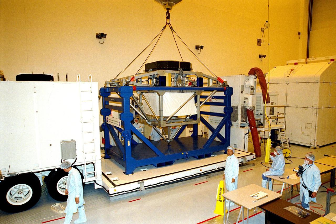 KENNEDY SPACE CENTER, FLA. -- The alpha-magnetic spectrometer (AMS-1) is lifted in KSC’s MultiPayload Processing Facility in preparation for a move to the Space Station Processing Facility via the Payload Environmental Transportation System. The STS-91 payload arrived at KSC in January and is scheduled to be flown on the 9th and final Mir docking mission, scheduled for launch in May. The objectives of the AMS-1 investigation are to search for anti-matter and dark matter in space and to study astrophysics. The STS-91 flight crew includes Commander Charles Precourt; Pilot Dominic Gorie; and Mission Specialists Wendy B. Lawrence; Franklin Chang-Diaz, Ph.D.; Janet Kavandi, Ph.D.; and Valery Ryumin, with the Russian Space Agency. After docking with the Russian Space Station Mir, Mission Specialist Andrew Thomas, Ph.D., will join the STS-91 crew and return to Earth aboard Discovery