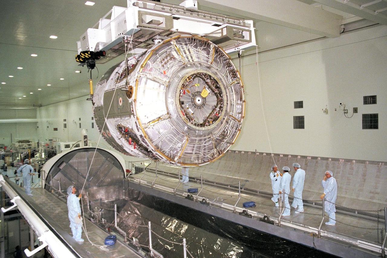KENNEDY SPACE CENTER, FLA. -- Node 1, the first U.S. element for the International Space Station, and attached Pressurized Mating Adapter-1 (PMA-1) are seen here being moved from the Shuttle payload transportation canister, where the doors were closed a week ago for a leak check in KSC's Space Station Processing Facility. Node 1 is a connecting passageway to the living and working areas of the space station. Since the node and PMA passed the test with flying colors, they were removed from the canister one week early in order to continue with other prelaunch preparation activities. Node 1 is scheduled to fly on STS-88