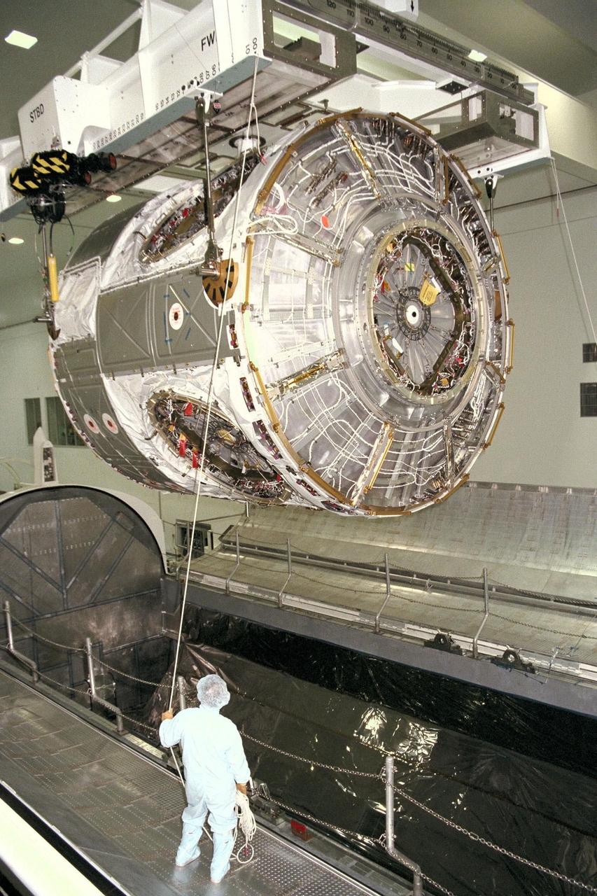 KENNEDY SPACE CENTER, FLA. -- Node 1, the first U.S. element for the International Space Station, and attached Pressurized Mating Adapter-1 (PMA-1) are seen here being moved from the Shuttle payload transportation canister, where the doors were closed a week ago for a leak check in KSC's Space Station Processing Facility. Node 1 is a connecting passageway to the living and working areas of the space station. Since the node and PMA passed the test with flying colors, they were removed from the canister one week early in order to continue with other prelaunch preparation activities. Node 1 is scheduled to fly on STS-88