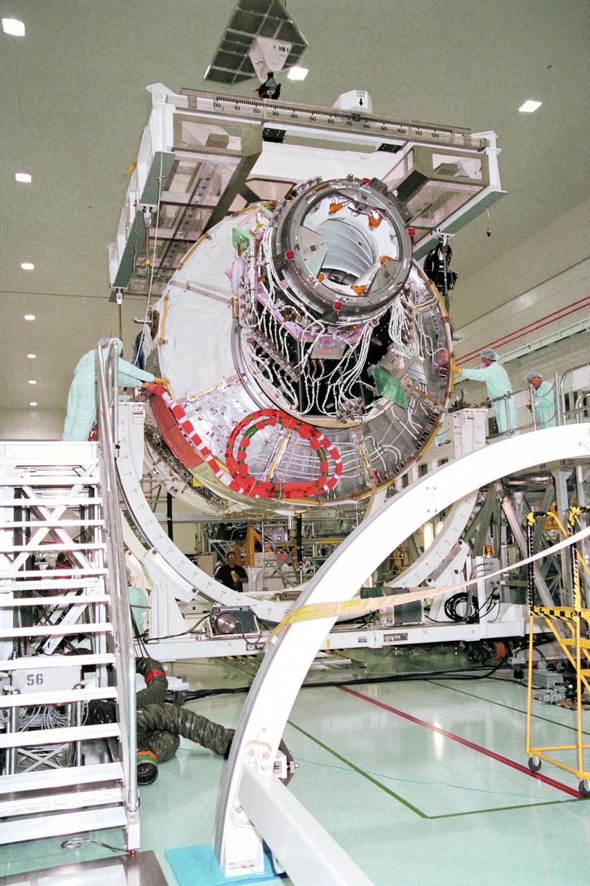 KENNEDY SPACE CENTER, FLA. -- Node 1, the first U.S. element for the International Space Station, and attached Pressurized Mating Adapter-1 (PMA-1) are seen here being moved into their test stand from the Shuttle payload transportation canister, where the doors were closed a week ago for a leak check in KSC's Space Station Processing Facility. Node 1 is a connecting passageway to the living and working areas of the space station. Since the node and PMA passed the test with flying colors, they were removed from the canister one week early in order to continue with other prelaunch preparation activities. Node 1 is scheduled to fly on STS-88