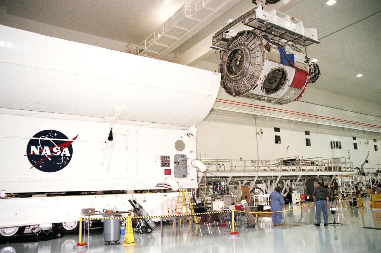 KENNEDY SPACE CENTER, FLA. -- Node 1, the first U.S. element for the International Space Station, and attached Pressurized Mating Adapter-1 (PMA-1) are seen here being moved from the Shuttle payload transportation canister, where the doors were closed a week ago for a leak check in KSC's Space Station Processing Facility. Node 1 is a connecting passageway to the living and working areas of the space station. Since the node and PMA passed the test with flying colors, they were removed from the canister one week early in order to continue with other prelaunch preparation activities. Node 1 is scheduled to fly on STS-88