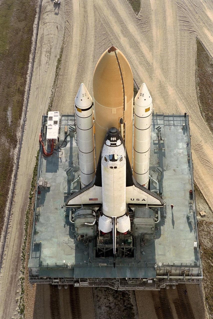 KENNEDY SPACE CENTER, FLA. -- The Space Shuttle Columbia continues its morning rollout from the Vehicle Assembly Building to Launch Pad 39B in preparation for the STS-90 mission. The Neurolab experiments are the primary payload on this nearly 17-day space flight. Investigations during the Neurolab mission will focus on the effects of microgravity on the nervous system. Specifically, experiments will study the adaptation of the vestibular system, the central nervous system, and the pathways that control the ability to sense location in the absence of gravity, as well as the effect of microgravity on a developing nervous system. The crew of STS-90, slated for launch April 16 at 2:19 p.m. EDT, includes Commander Richard Searfoss, Pilot Scott Altman, Mission Specialists Richard Linnehan, Dafydd (Dave) Williams, M.D., and Kathryn (Kay) Hire, and Payload Specialists Jay Buckey, M.D., and James Pawelczyk, Ph.D