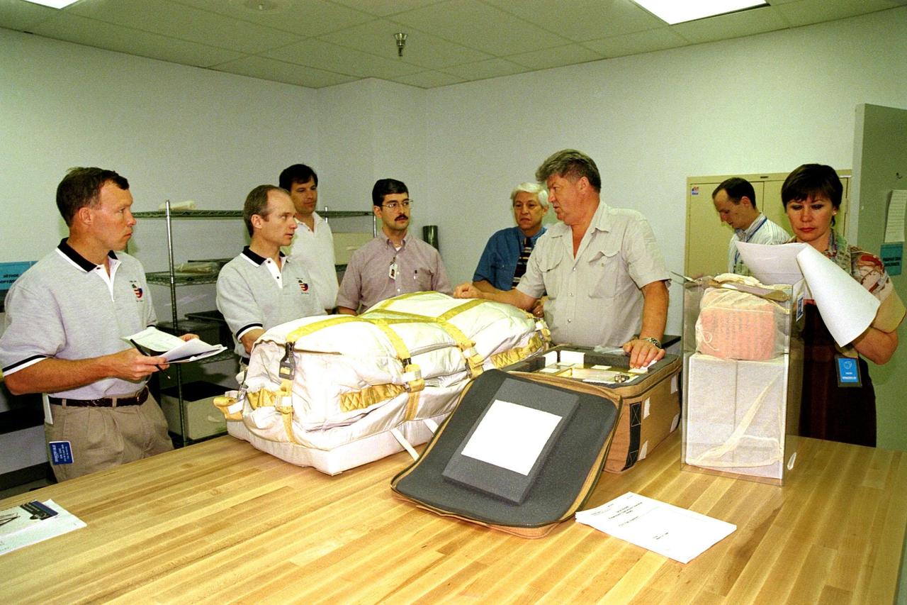 The STS-91 crew participate in the Crew Equipment Interface Test (CEIT) for their upcoming Space Shuttle mission at the SPACEHAB Payload Processing Facility in Cape Canaveral. The CEIT gives astronauts an opportunity to get a hands-on look at the payloads with which they will be working on-orbit. STS-91 will be the ninth and final scheduled Mir docking and will include a single module of SPACEHAB, used mainly as a large pressurized cargo container for science, logistical equipment and supplies to be exchanged between the orbiter Discovery and the Russian Space Station Mir. The nearly 10-day flight of STS-91 also is scheduled to include the return of the last astronaut to live and work aboard the Russian orbiting outpost, Mission Specialist Andy Thomas, Ph.D. Liftoff of Discovery and its six-member crew is targeted for May 28, 1998, at 8:05 p.m. EDT from Launch Pad 39A. From left to right are STS-91 Pilot Dominic Gorie, STS-91 Commander Charles Precourt, Boeing SPACEHAB Payload Operations Senior Engineer Jim Behling, Boeing SPACEHAB Program Senior Engineer Shawn Hicks, Boeing SPACEHAB Program Specialist in Engineering Ed Saenger, STS-91 Mission Specialist Valery Ryumin with the Russian Space Agency, Boeing SPACEHAB Program Manager in Engineering Brad Reid, and Russian Interpreter Olga Belozerova