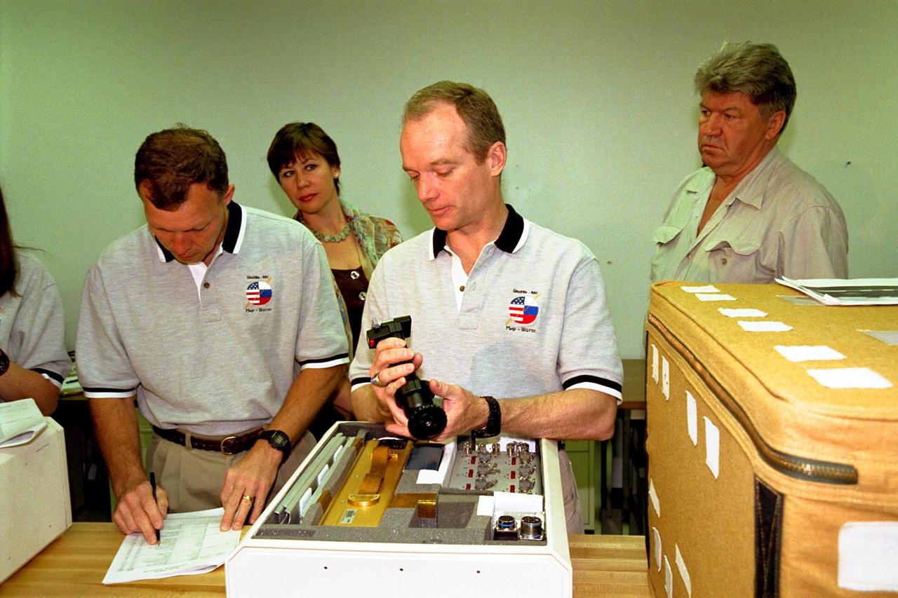 KENNEDY SPACE CENTER, FLA. -- The STS-91 crew participate in the Crew Equipment Interface Test (CEIT) for their upcoming Space Shuttle mission at the SPACEHAB Payload Processing Facility in Cape Canaveral. The CEIT gives astronauts an opportunity to get a hands-on look at the payloads with which they will be working on-orbit. STS-91 will be the ninth and final scheduled Mir docking and will include a single module of SPACEHAB, used mainly as a large pressurized cargo container for science, logistical equipment and supplies to be exchanged between the orbiter Discovery and the Russian Space Station Mir. The nearly 10-day flight of STS-91 also is scheduled to include the return of the last astronaut to live and work aboard the Russian orbiting outpost, Mission Specialist Andy Thomas, Ph.D. Liftoff of Discovery and its six-member crew is targeted for May 28, 1998, at 8:05 p.m. EDT from Launch Pad 39A. From left to right are STS-91 Pilot Dominic Gorie, Russian Interpreter Olga Belozerova, STS-91 Commander Charles Precourt, and STS-91 Mission Specialist Valery Ryumin with the Russian Space Agency