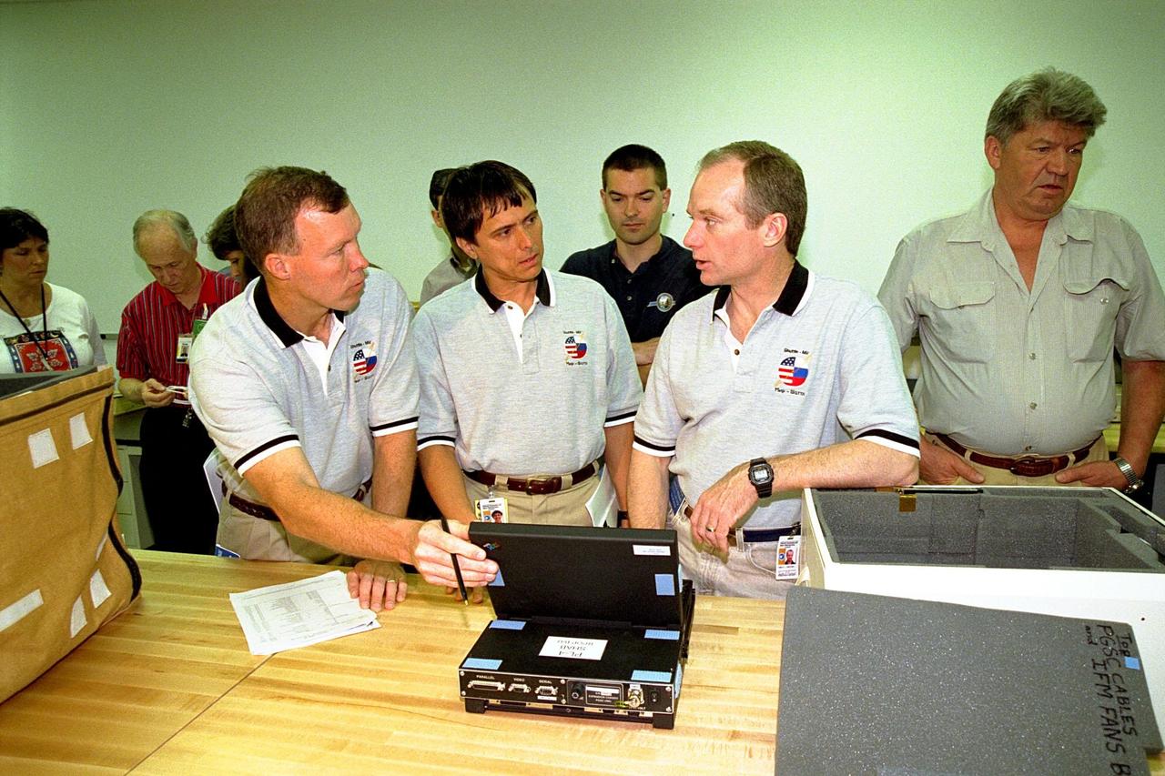 KENNEDY SPACE CENTER, FLA. -- The STS-91 crew participate in the Crew Equipment Interface Test (CEIT) for their upcoming Space Shuttle mission at the SPACEHAB Payload Processing Facility in Cape Canaveral. The CEIT gives astronauts an opportunity to get a hands-on look at the payloads with which they will be working on-orbit. STS-91 will be the ninth and final scheduled Mir docking and will include a single module of SPACEHAB, used mainly as a large pressurized cargo container for science, logistical equipment and supplies to be exchanged between the orbiter Discovery and the Russian Space Station Mir. The nearly 10-day flight of STS-91 also is scheduled to include the return of the last astronaut to live and work aboard the Russian orbiting outpost, Mission Specialist Andy Thomas, Ph.D. Liftoff of Discovery and its six-member crew is targeted for May 28, 1998, at 8:05 p.m. EDT from Launch Pad 39A. At far left is Boeing SPACEHAB Program Senior Engineer Ellen Styles, and around the table are, left to right, STS-91 Pilot Dominic Gorie, STS-91 Mission Specialist Franklin Chang-Diaz, Ph.D., Boeing SPACEHAB Program Senior Engineer Chris Jazkolka, STS-91 Commander Charles Precourt, and STS-91 Mission Specialist Valery Ryumin with the Russian Space Agency