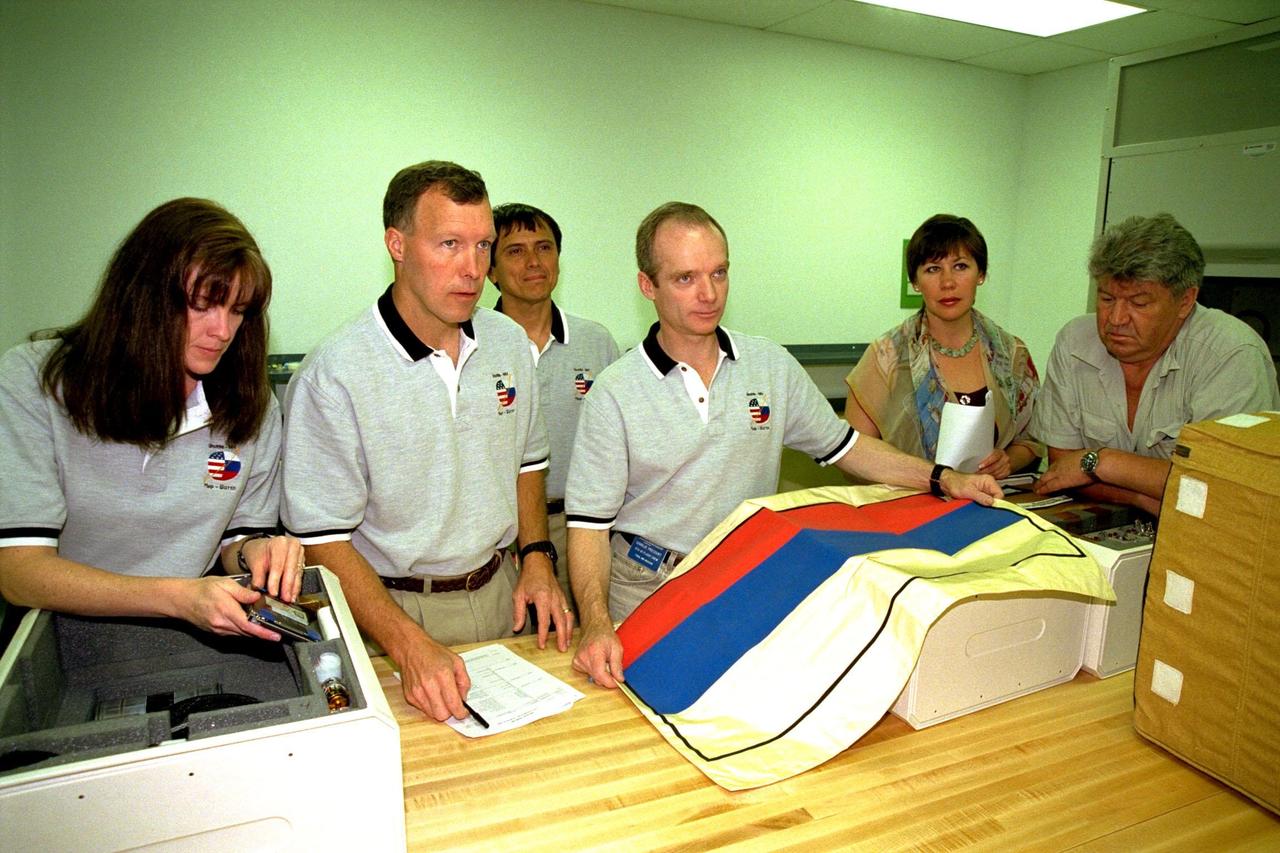 KENNEDY SPACE CENTER, FLA. -- The STS-91 crew participate in the Crew Equipment Interface Test (CEIT) for their upcoming Space Shuttle mission at the SPACEHAB Payload Processing Facility in Cape Canaveral. The CEIT gives astronauts an opportunity to get a hands-on look at the payloads with which they will be working on-orbit. STS-91 will be the ninth and final scheduled Mir docking and will include a single module of SPACEHAB, used mainly as a large pressurized cargo container for science, logistical equipment and supplies to be exchanged between the orbiter Discovery and the Russian Space Station Mir. The nearly 10-day flight of STS-91 also is scheduled to include the return of the last astronaut to live and work aboard the Russian orbiting outpost, Mission Specialist Andy Thomas, Ph.D. Liftoff of Discovery and its six-member crew is targeted for May 28, 1998, at 8:05 p.m. EDT from Launch Pad 39A. From left to right are Mission Specialist Janet Kavandi, Ph.D., Pilot Dominic Gorie, Mission Specialist Franklin Chang-Diaz, Ph.D., Commander Charles Precourt, Russian Interpreter Olga Belozerova, and Mission Specialist Valery Ryumin with the Russian Space Agency