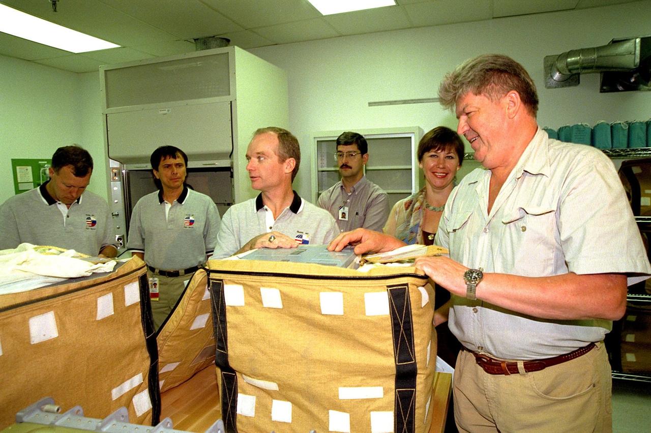 KENNEDY SPACE CENTER, FLA. -- The STS-91 crew participate in the Crew Equipment Interface Test (CEIT) for their upcoming Space Shuttle mission at the SPACEHAB Payload Processing Facility in Cape Canaveral. The CEIT gives astronauts an opportunity to get a hands-on look at the payloads with which they will be working on-orbit. STS-91 will be the ninth and final scheduled Mir docking and will include a single module of SPACEHAB, used mainly as a large pressurized cargo container for science, logistical equipment and supplies to be exchanged between the orbiter Discovery and the Russian Space Station Mir. The nearly 10-day flight of STS-91 also is scheduled to include the return of the last astronaut to live and work aboard the Russian orbiting outpost, Mission Specialist Andy Thomas, Ph.D. Liftoff of Discovery and its six-member crew is targeted for May 28, 1998, at 8:05 p.m. EDT from Launch Pad 39A. From left to right are STS-91 Pilot Dominic Gorie, STS-91 Mission Specialist Franklin Chang-Diaz, Ph.D., STS-91 Commander Charles Precourt, Boeing SPACEHAB Program Senior Engineer Shawn Hicks, Russian Interpreter Olga Belozerova, and STS-91 Mission Specialist Valery Ryumin with the Russian Space Agency