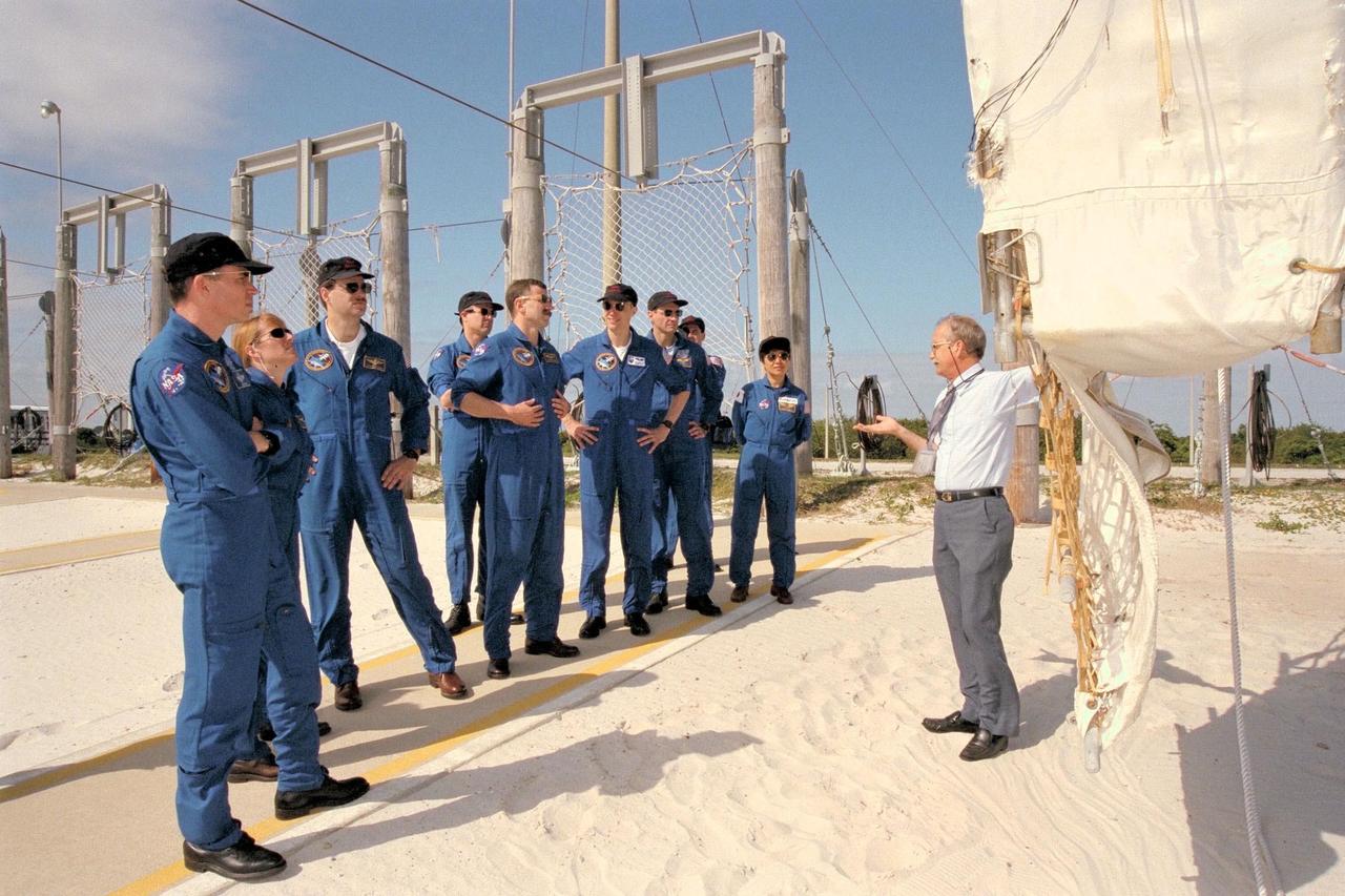 Members of the STS-90 flight crew train in the braking pit area for the emergency egress system slidewire baskets for Launch Pad 39B during Terminal Countdown Demonstration Test (TCDT) activities for that mission. The TCDT is held at KSC prior to each Space Shuttle flight to provide crews with the opportunity to participate in simulated countdown activities. From left to right are Commander Richard Searfoss, Mission Specialist Kathryn (Kay) Hire, Pilot Scott Altman, Payload Specialist Jay Buckey, M.D. (behind), Mission Specialist Dafydd (Dave) Williams, M.D., with the Canadian Space Agency, Payload Specialist James Pawelczyk, Ph.D., and Mission Specialist Richard Linnehan, D.V.M. Backup Payload Specialists Alexander Dunlap (holding camera), D.V.M., M.D., and Chiaki Mukai, M.D., Ph.D., with the National Space Development Agency of Japan are also listening to USA technical trainer Bob Parks' instruction. Columbia is targeted for launch of STS-90 on April 16 at 2:19 p.m. EDT and will be the second mission of 1998. The mission is scheduled to last nearly 17 days