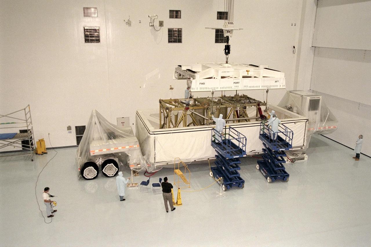 KENNEDY SPACE CENTER, FLA. -- The Long Spacer, a component of the International Space Station, arrives and is moved to its test stand in the northeast corner of the high bay in KSC's Space Station Processing Facility. The Long Spacer provides structural support for the outboard Photovoltaic Modules that supply power to the station. Now just a structure, the Long Spacer will have attached to it as part of processing a heat dissipation radiator and two Pump and Flow Control subassemblies that circulate ammonia to cool the solar array electronics. Also to be mounted are ammonia fluid lines as part of the cooling system and the cabling necessary for power and control of the station. The Long Spacer becomes an integral part of a station truss segment when it is mated with the Integrated Equipment Assembly, which stores the electrical power generated by the solar arrays for use by the station modules. The Long Spacer is being processed in preparation for STS-97, currently planned for launch aboard Discovery in April 1999