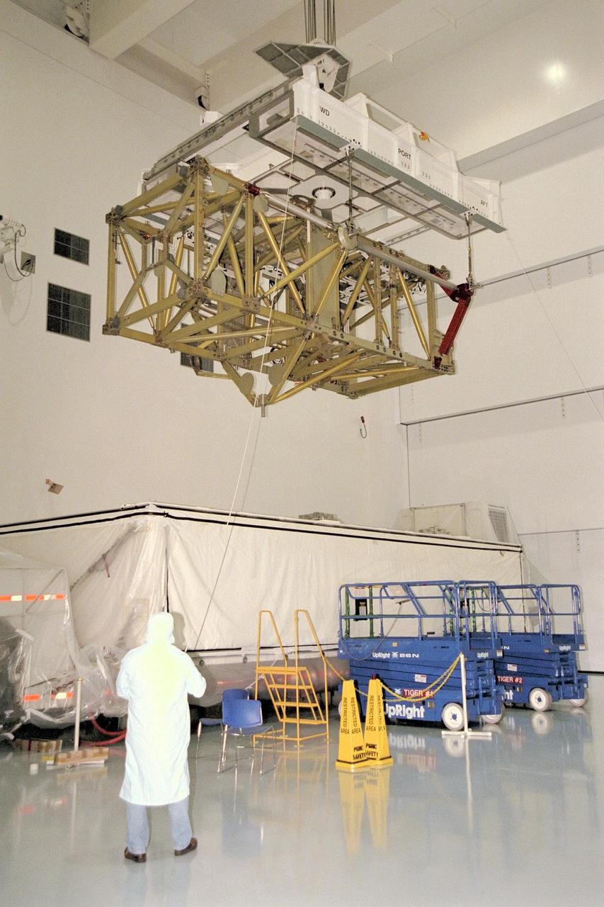 KENNEDY SPACE CENTER, FLA. -- The Long Spacer, a component of the International Space Station, arrives and is moved to its test stand in the northeast corner of the high bay in KSC's Space Station Processing Facility. The Long Spacer provides structural support for the outboard Photovoltaic Modules that supply power to the station. Now just a structure, the Long Spacer will have attached to it as part of processing a heat dissipation radiator and two Pump and Flow Control subassemblies that circulate ammonia to cool the solar array electronics. Also to be mounted are ammonia fluid lines as part of the cooling system and the cabling necessary for power and control of the station. The Long Spacer becomes an integral part of a station truss segment when it is mated with the Integrated Equipment Assembly, which stores the electrical power generated by the solar arrays for use by the station modules. The Long Spacer is being processed in preparation for STS-97, currently planned for launch aboard Discovery in April 1999