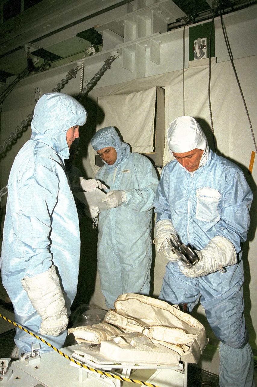 The STS-91 crew participate in the Crew Equipment Interface Test, or CEIT, in KSC's Orbiter Processing Facility Bay 2. Left to right are STS-91 Mission Specialist Janet Kavandi, Ph.D.; KSC's Vehicle Integration Test Team member Danny Wittington; and STS-91 Mission Specialist Franklin Chang-Diaz, Ph.D. During CEIT, the crew have an opportunity to get a hands-on look at the payloads with which they'll be working on-orbit. The STS-91 crew are scheduled to launch aboard the Shuttle Discovery for the ninth and final docking with the Russian Space Station Mir from KSC's Launch Pad 39A on May 28 at 8:05 EDT
