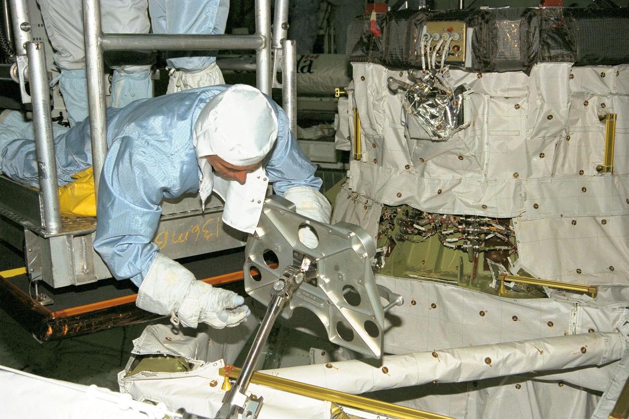 STS-91 Mission Specialist Franklin Chang-Diaz, Ph.D., participates in the Crew Equipment Interface Test, or CEIT, in KSC's Orbiter Processing Facility Bay 2. He is inspecting a foot restraint for an external vehicular activity (EVA) spacewalk. During CEIT, the crew have an opportunity to get a hands-on look at the payloads and equipment with which they'll be working on-orbit. The STS-91 crew are scheduled to launch aboard the Shuttle Discovery for the ninth and final docking with the Russian Space Station Mir from KSC's Launch Pad 39A on May 28 at 8:05 EDT