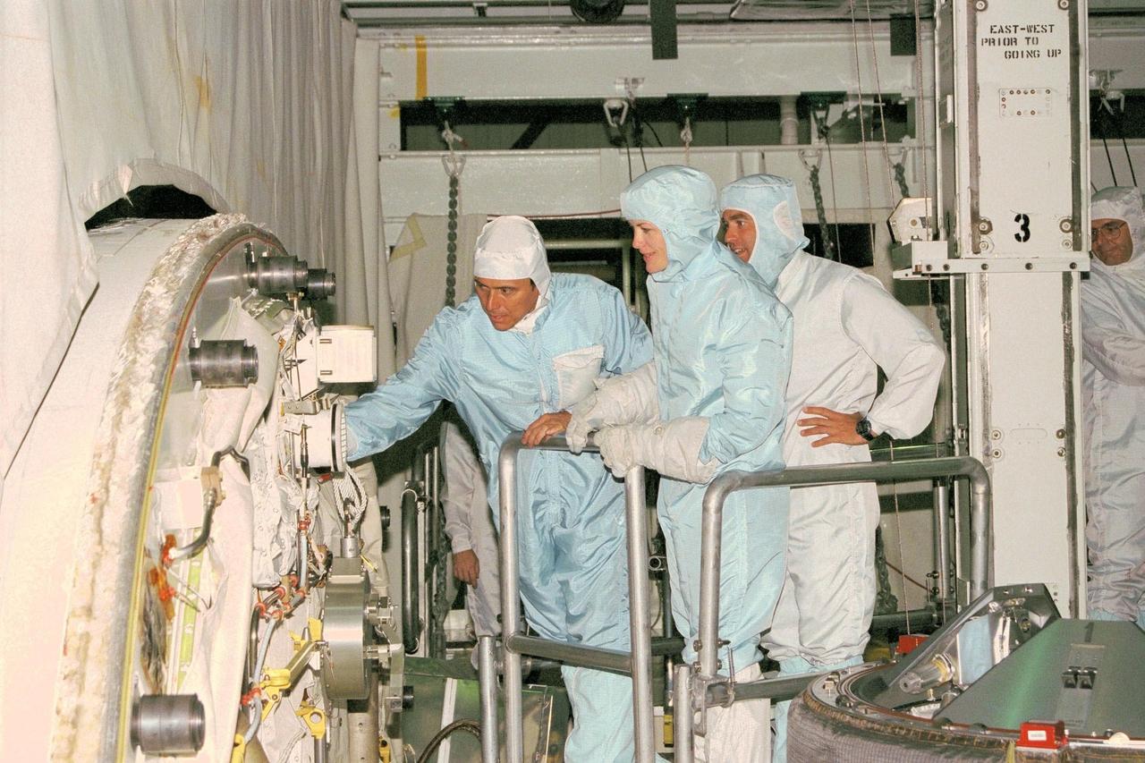 STS-91 crew members participate in the Crew Equipment Interface Test, or CEIT, in KSC's Orbiter Processing Facility Bay 2. From left to right are STS-91 Mission Specialists Franklin Chang-Diaz, Ph.D., and Janet Kavandi, Ph.D., along with Kieth Johnson, an EVA trainer/flight controller from Johnson Space Center. During CEIT, the crew have an opportunity to get a hands-on look at the payloads with which they'll be working on-orbit. The STS-91 crew are scheduled to launch aboard the Shuttle Discovery for the ninth and final docking with the Russian Space Station Mir from KSC's Launch Pad 39A on May 28 at 8:05 EDT