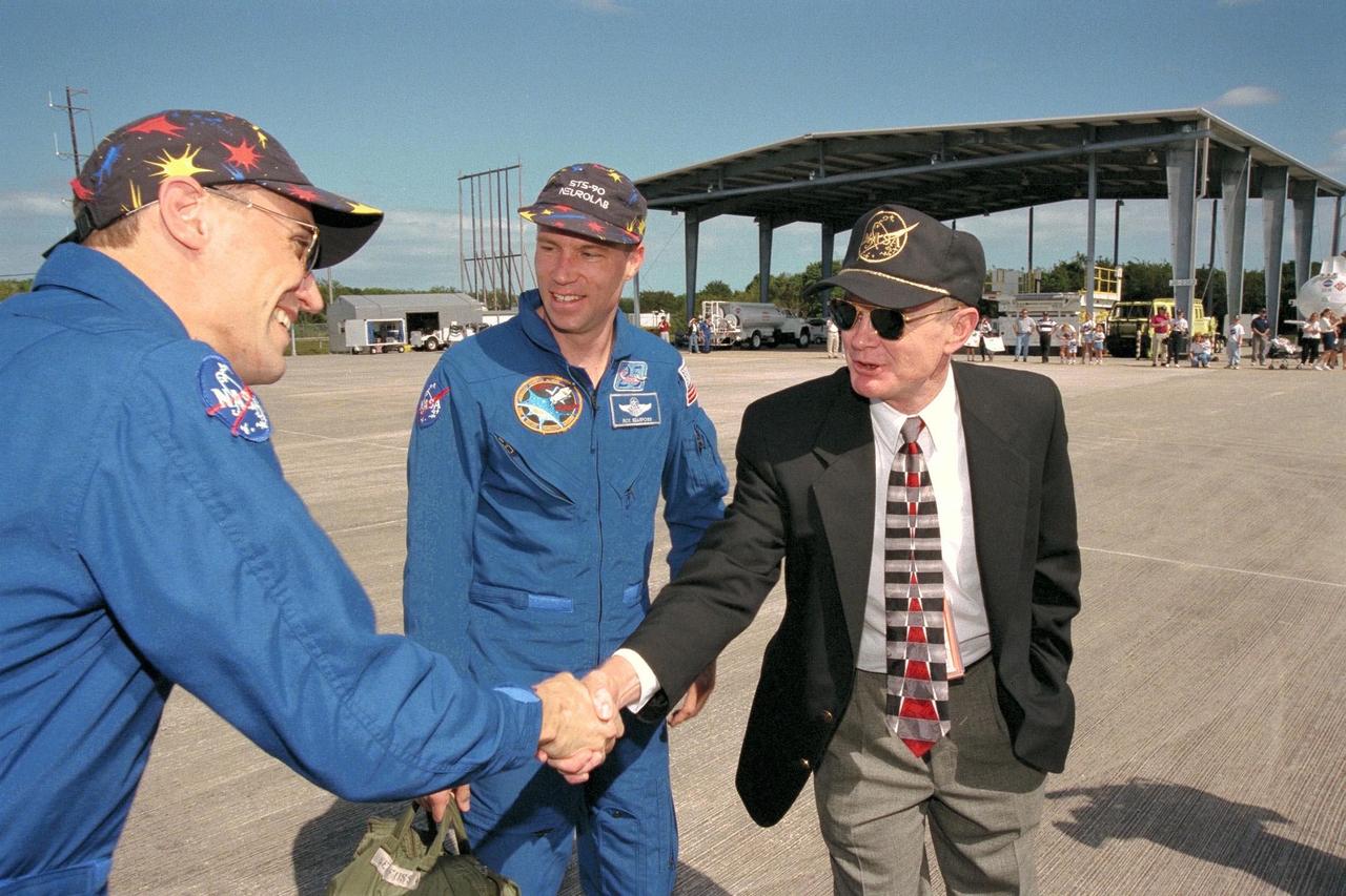 KENNEDY SPACE CENTER, FLA. -- STS-90 Payload Specialist James Pawelczyk, Ph.D. (at left), shakes the hand of KSC Director Roy Bridges as STS-90 Commander Richard Searfoss looks on shortly after the crew's arrival at Kennedy Space Center's Shuttle Landing Facility. The crew arrived to prepare for the launch of Columbia, scheduled for April 16 at 2:19 p.m. EDT from KSC's Launch Pad 39B. The launch of Neurolab on STS-90, which will be the second mission of 1998, is scheduled to last nearly 17 days