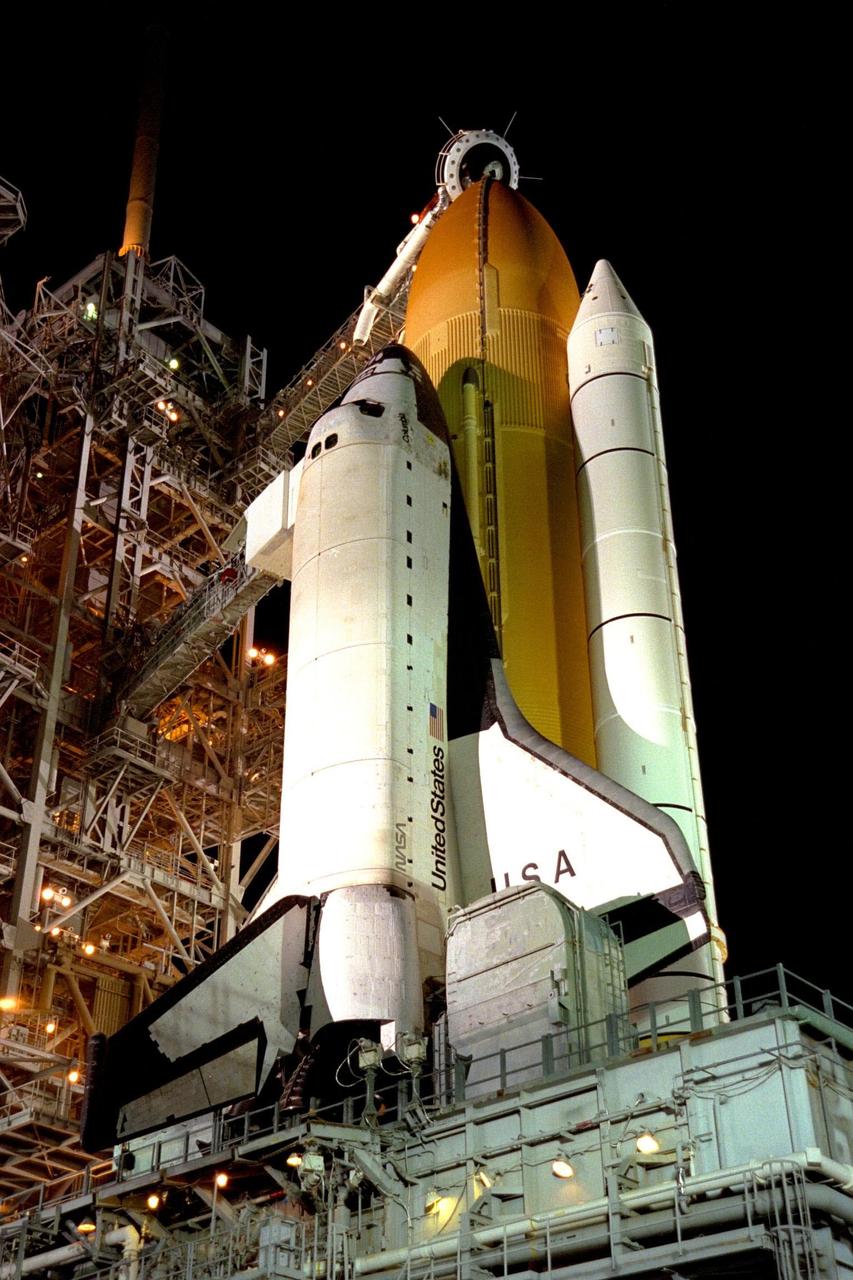 KENNEDY SPACE CENTER, FLA. -- With the Rotating Service Structure (RSS) rolled back, at left, the Space Shuttle Columbia is nearly ready for launch of STS-90. Rollback of the RSS is a major preflight milestone, typically occurring during the T-11-hour hold on L-1 (the day before launch). The scheduled launch of Columbia on Apr. 16 from Launch Pad 39B was postponed 24 hours due to difficulty with network signal processor No. 2 on the orbiter. This device formats data and voice communications between the ground and the Space Shuttle. The unit, which is located in the orbiter's mid-deck, will be removed and replaced. Prior to launch, one of the final steps will be to load the external tank with approximately 500,000 gallons of liquid hydrogen and liquid oxygen for fueling the orbiters three main engines. Tanking had not yet begun when the launch scheduled for Apr. 16 was scrubbed. STS-90 is slated to be the launch of Neurolab, a nearly 17-day mission to examine the effects of spaceflight on the brain, spinal cord, peripheral nerves and sensory organs in the human body